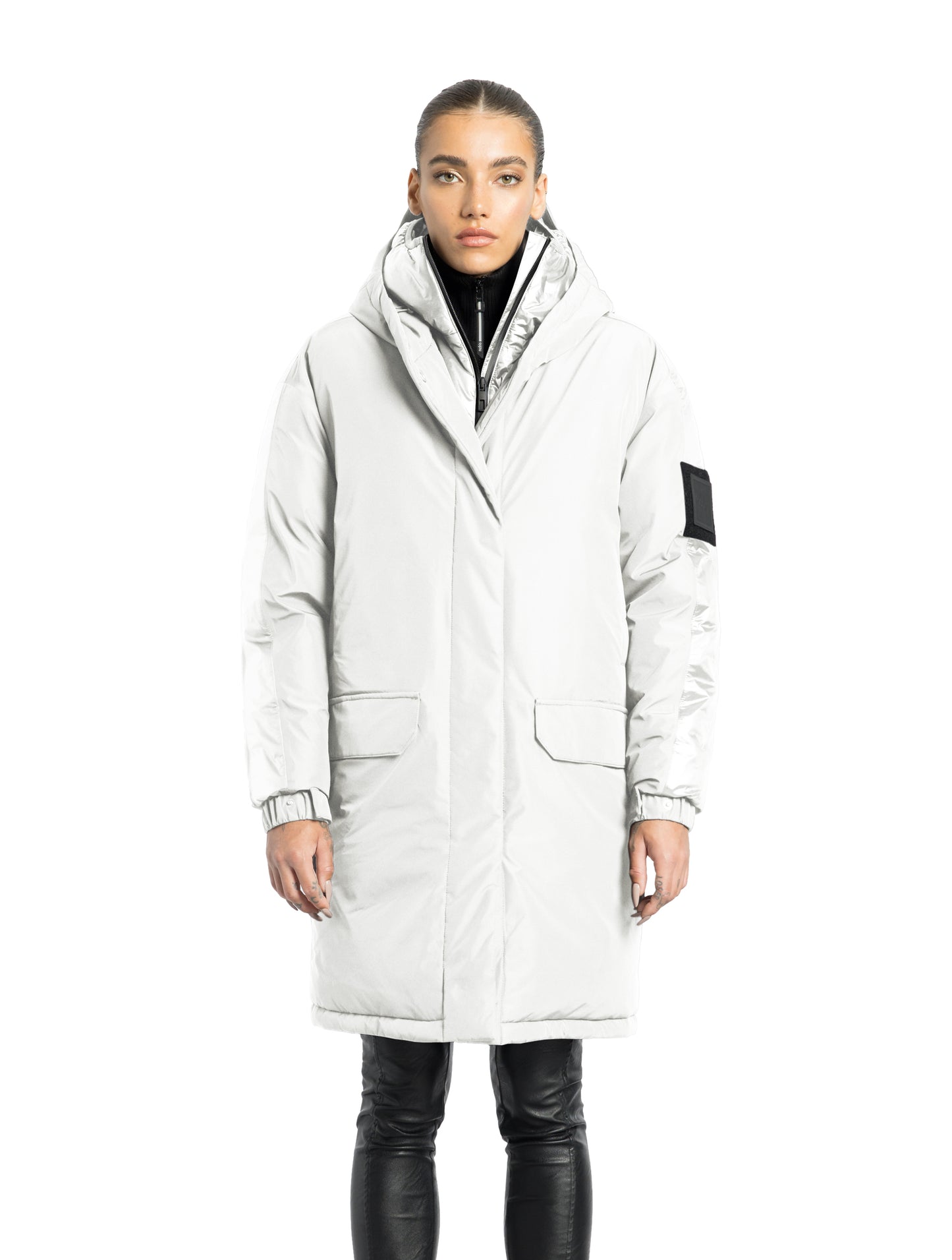 Slyn Women's Performance Parka in thigh length, premium 3-ply micro denier and cire technical nylon taffeta fabrication, Premium Canadian origin White Duck Down insulation, non-removable down-filled hood, inner hooded gilet, two-way centre-front zipper with magnetic closure wind flap, fleece-lined pockets at chest and waist, pit zipper vents, in Chalk