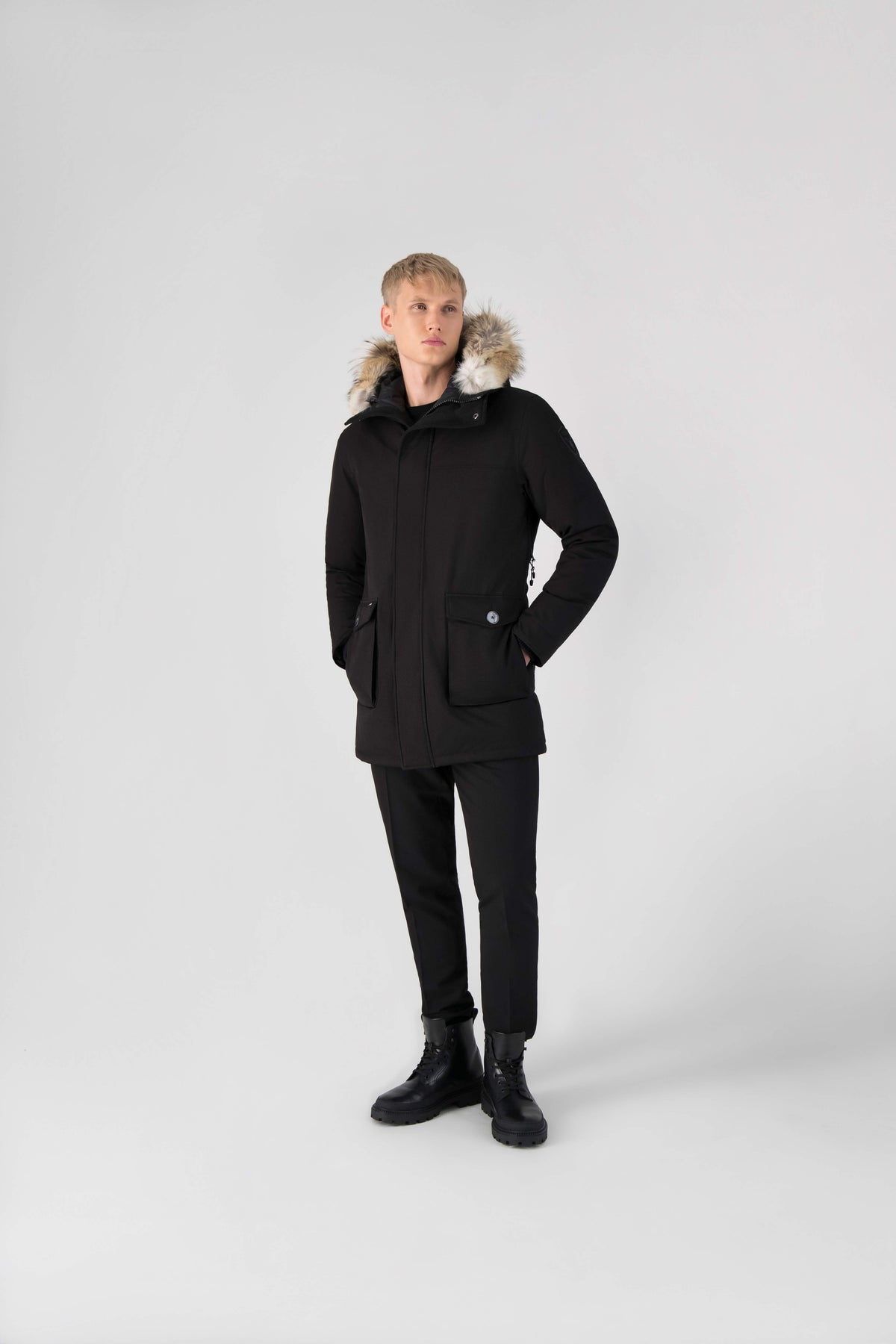 Men's slim fitting waist length parka with removable fur trim on the hood and two waist patch pockets in Black