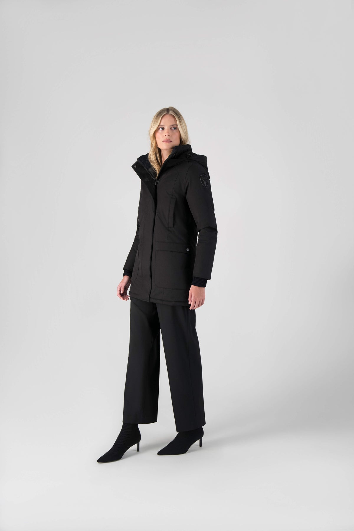 Women's down filled parka that sits just below the hip with a clean look and two hip patch pockets in Black