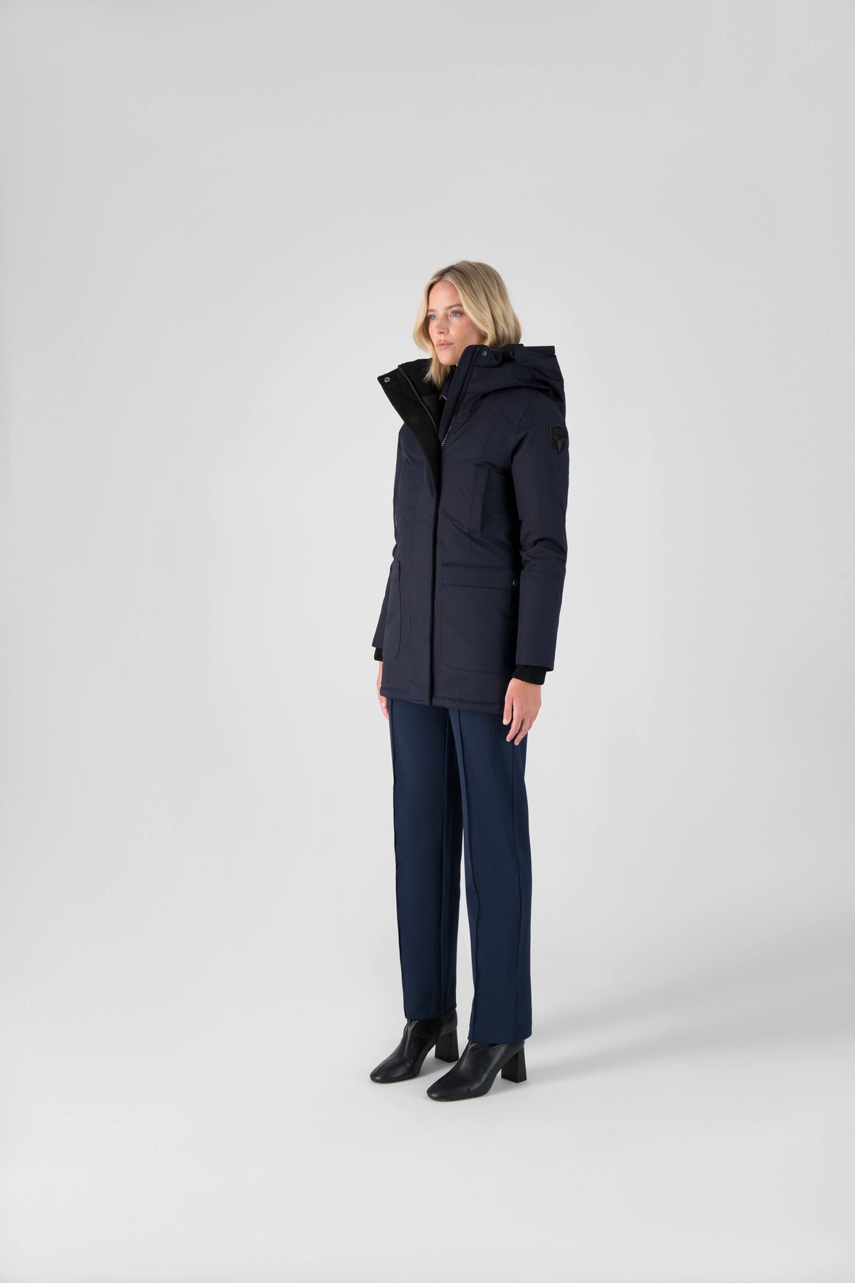 Women's down filled parka that sits just below the hip with a clean look and two hip patch pockets in Navy