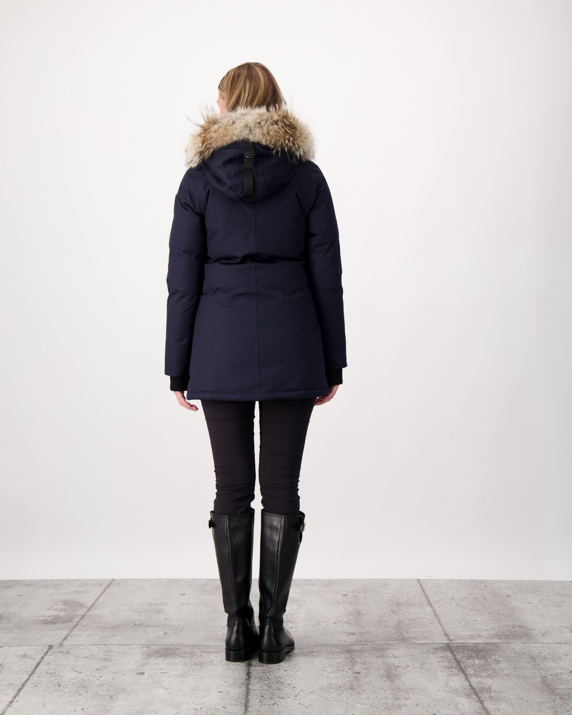 Women's down filled parka that sits just below the hip with a clean look and two hip patch pockets in Navy