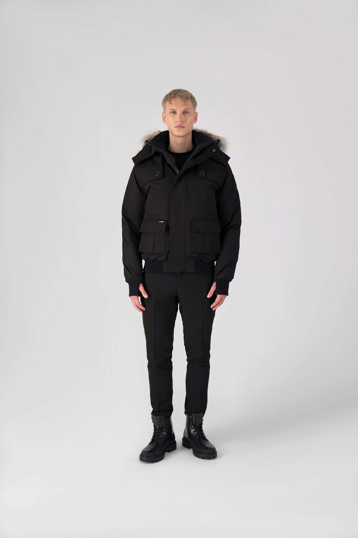 Men's down filled bomber that sits just above the hips with a completely removable hood that's windproof, waterproof, and breathable in Black