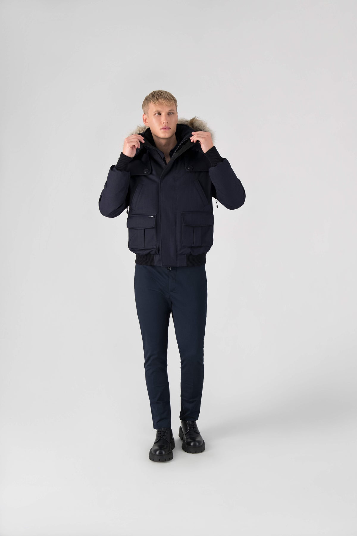 Men's down filled bomber that sits just above the hips with a completely removable hood that's windproof, waterproof, and breathable in Navy