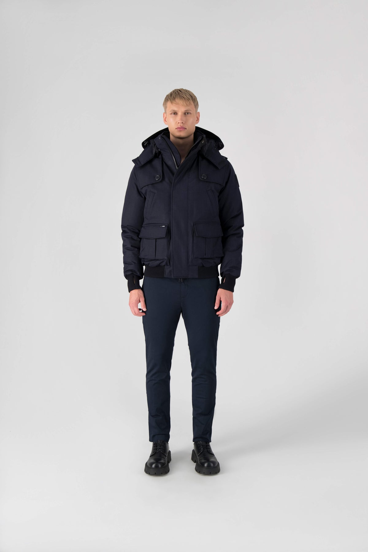 Men's down filled bomber that sits just above the hips with a completely removable hood that's windproof, waterproof, and breathable in Navy