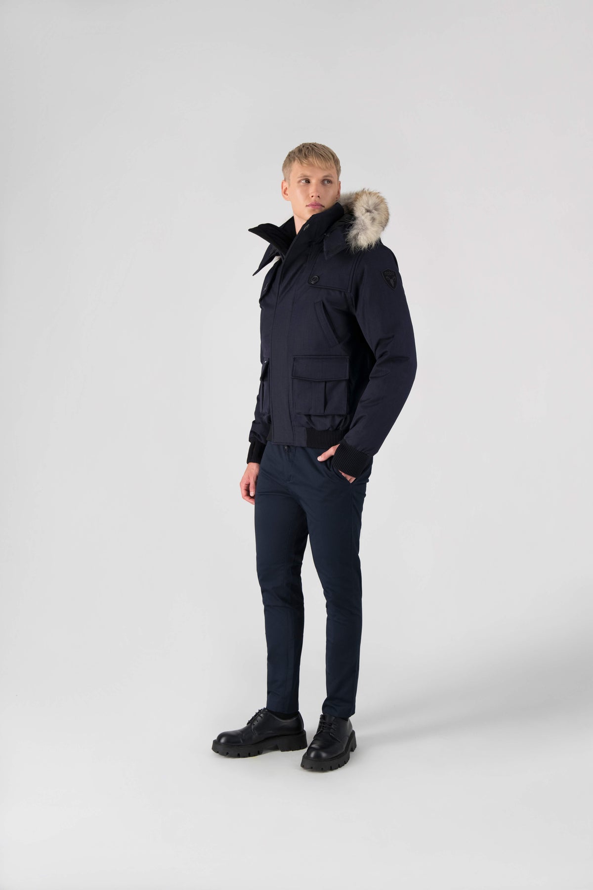 Men's down filled bomber that sits just above the hips with a completely removable hood that's windproof, waterproof, and breathable in Navy