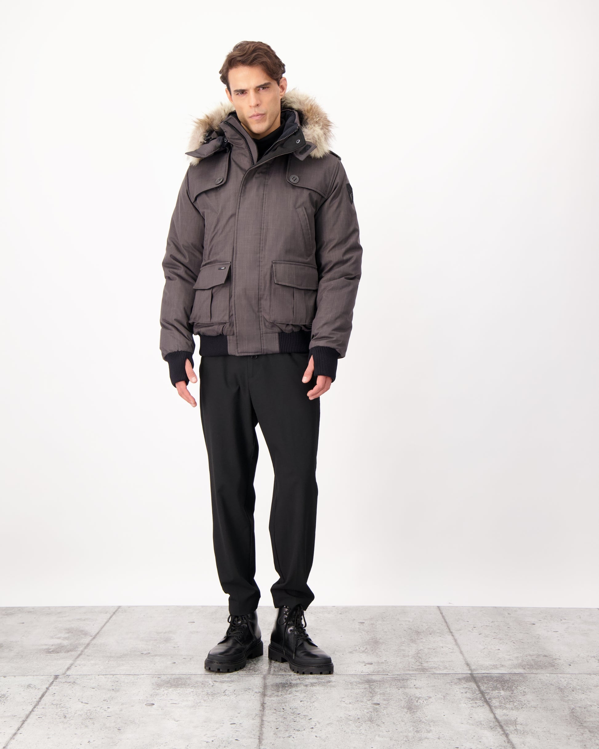 Men's down filled bomber that sits just above the hips with a completely removable hood that's windproof, waterproof, and breathable in CH Steel Grey