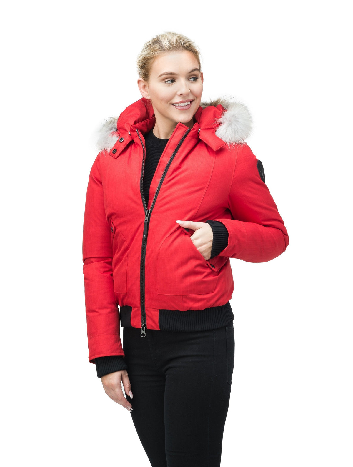 Women's bomber style down filled jacket with a removable hood and fur trim in Red