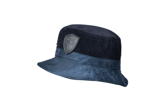 Kaia Unisex Tailored Bucket Hat in a 100% cotton corduroy and 3-ply micro denier fabrication, unstructured crown, black leather Nobis shield logo on crown front, and small flap pocket on the right side crown, in Navy + Navy