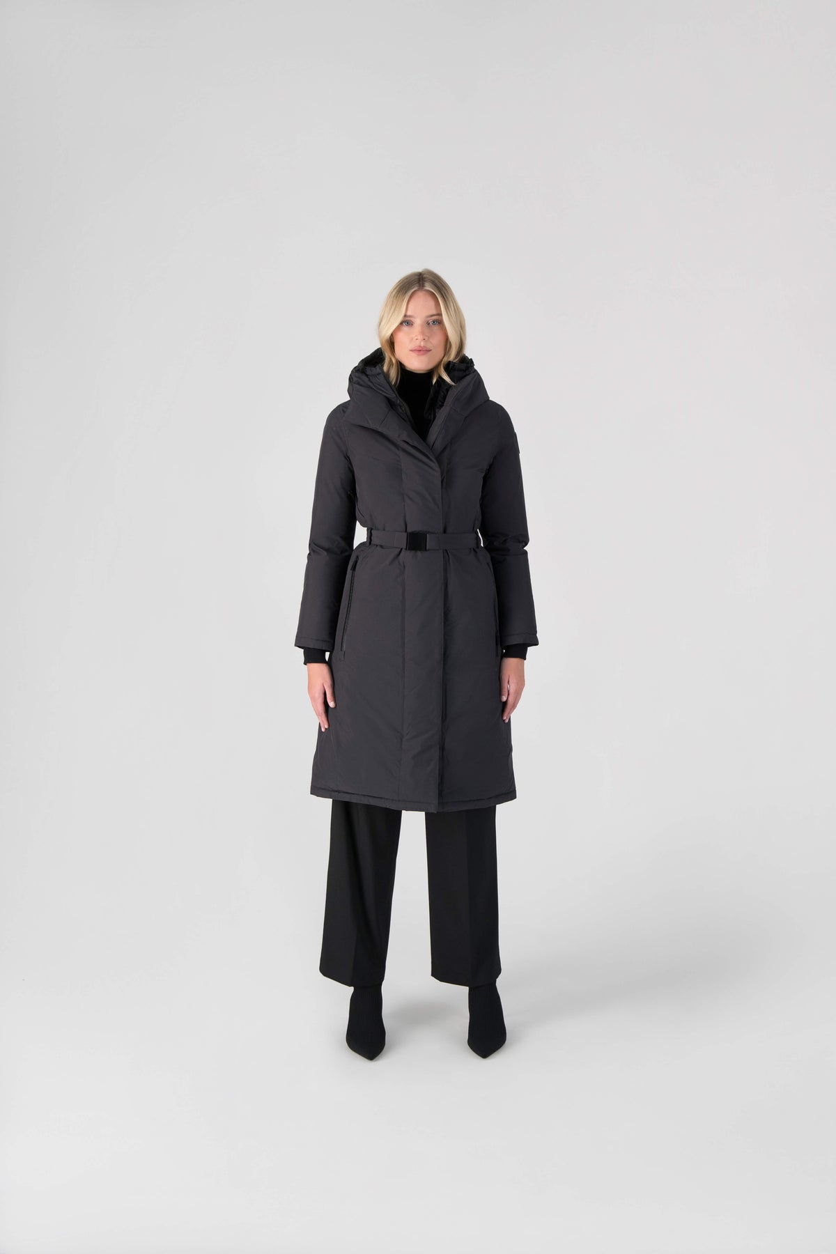Long calf length hooded women's winter parka with an inner hip length closure, exterior hem length zipper and magnetic placket in Black