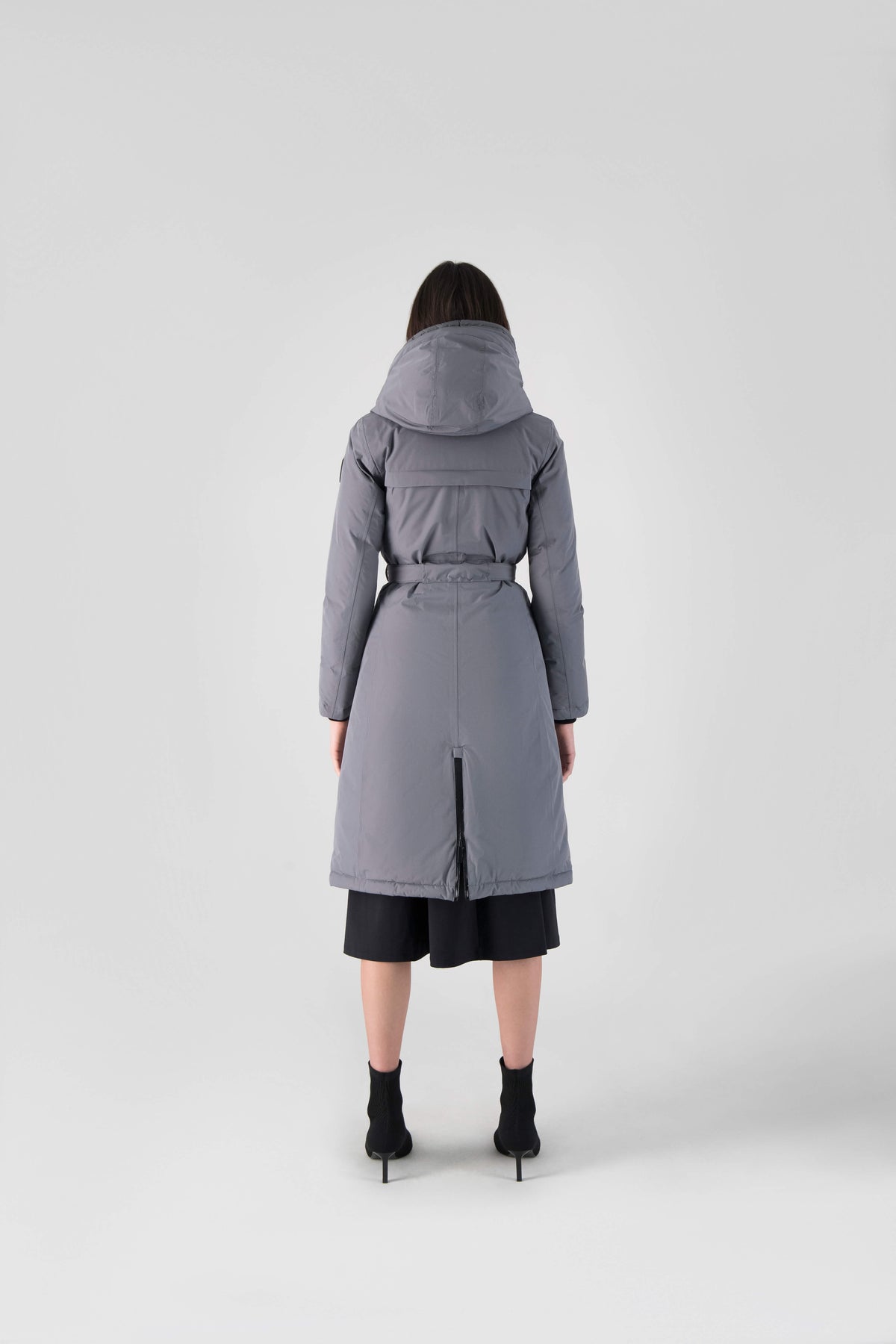 Long calf length hooded women's winter parka with an inner hip length closure, exterior hem length zipper and magentic placket in Concrete