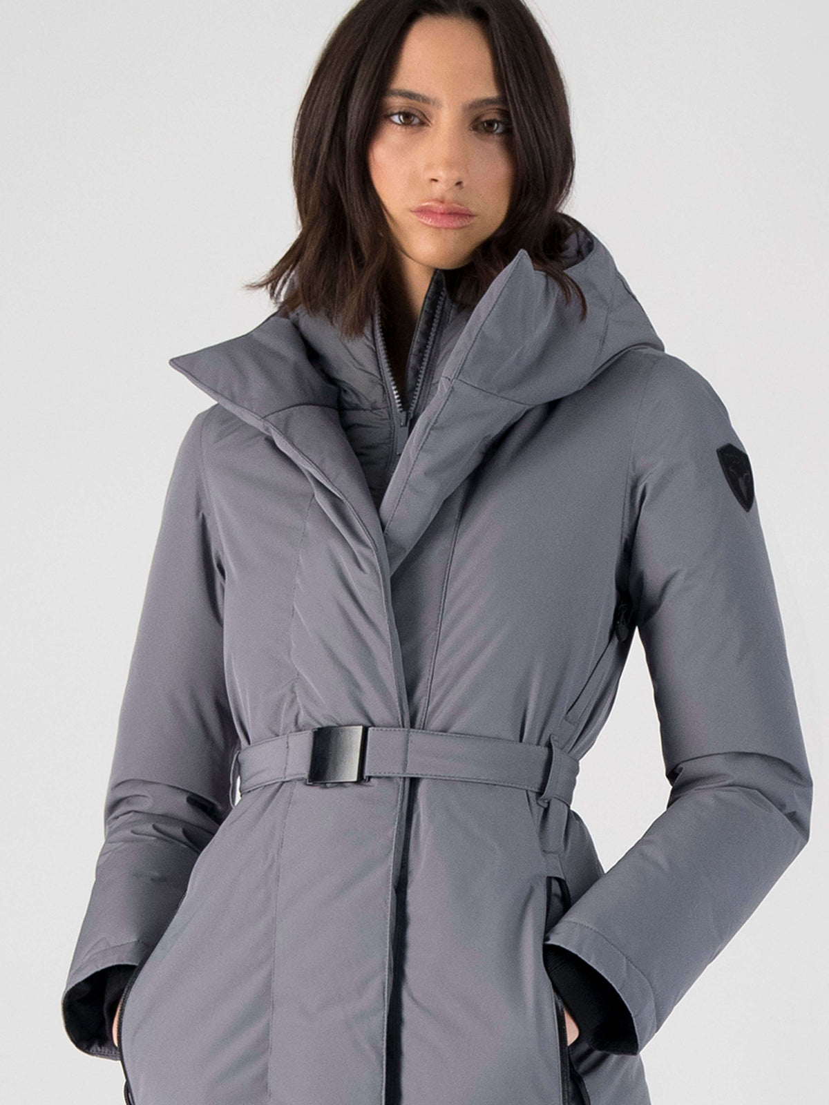 Long calf length hooded women's winter parka with an inner hip length closure, exterior hem length zipper and magentic placket in Concrete