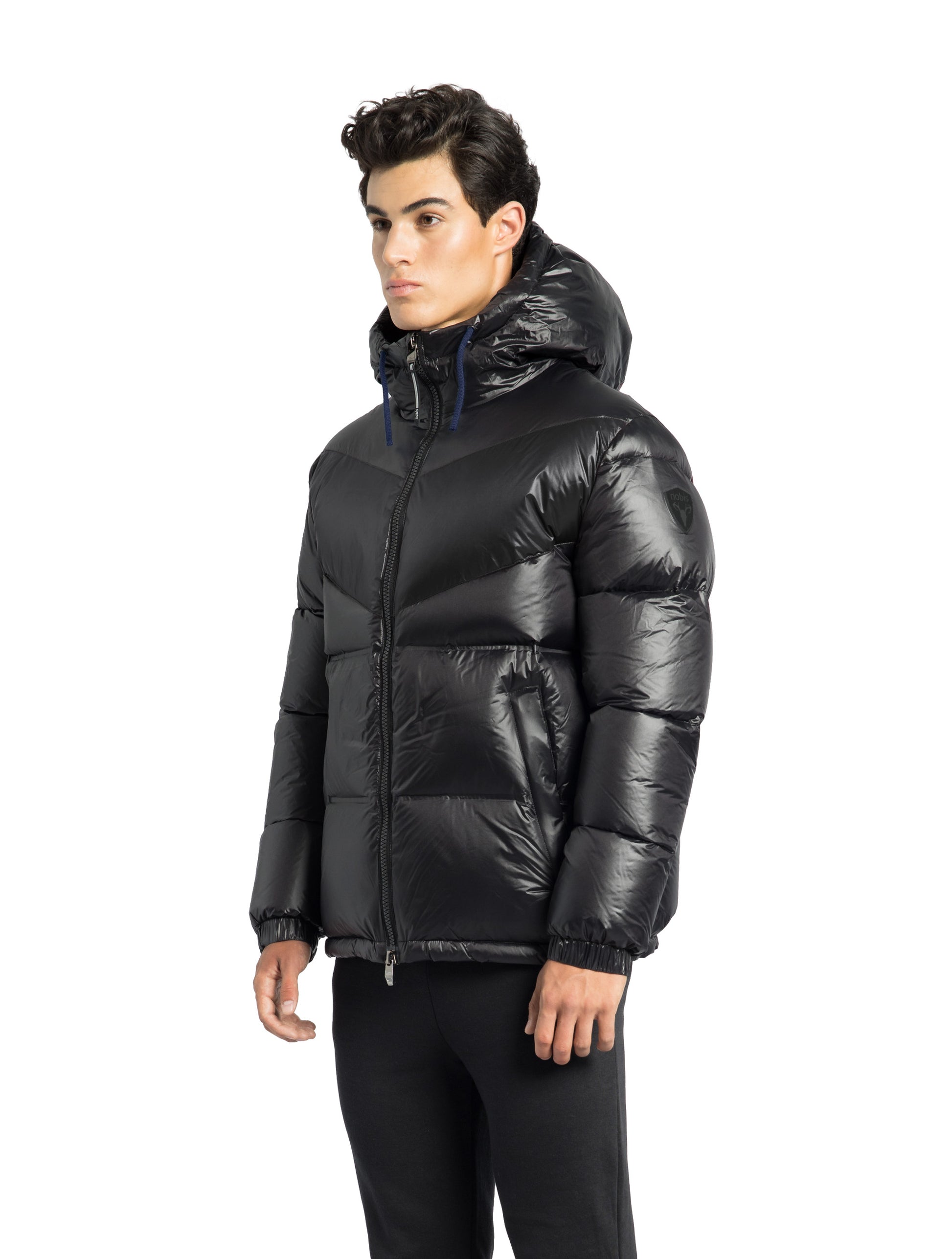 Dyna Men's Chevron Quilted Puffer Jacket in hip length, premium cire technical nylon taffeta fabrication, Premium Canadian origin White Duck Down insulation, non-removable down-filled hood, two-way centre-front zipper, fleece-lined zipper pockets at waist, pit zipper vents, in Black