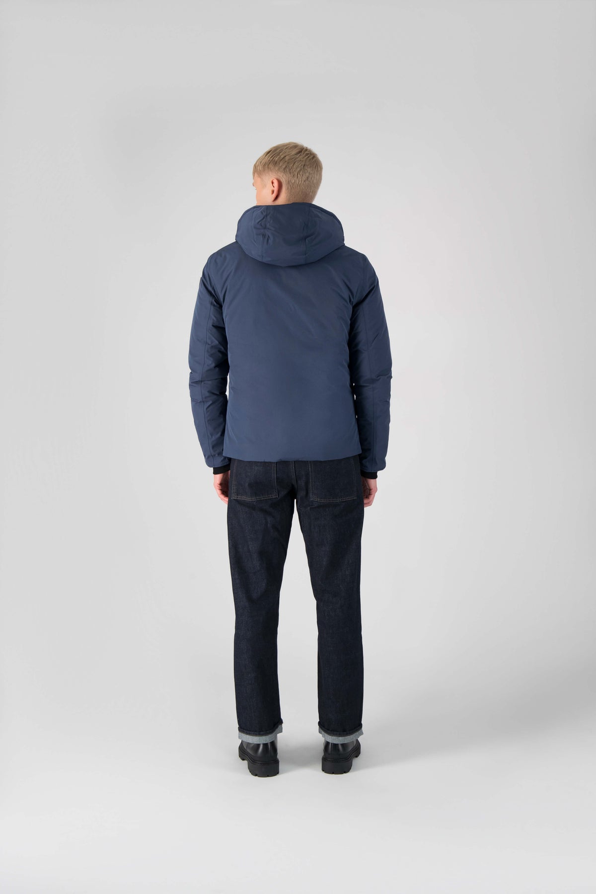 Hip length, reversible men's down filled jacket with removable hood in Marine