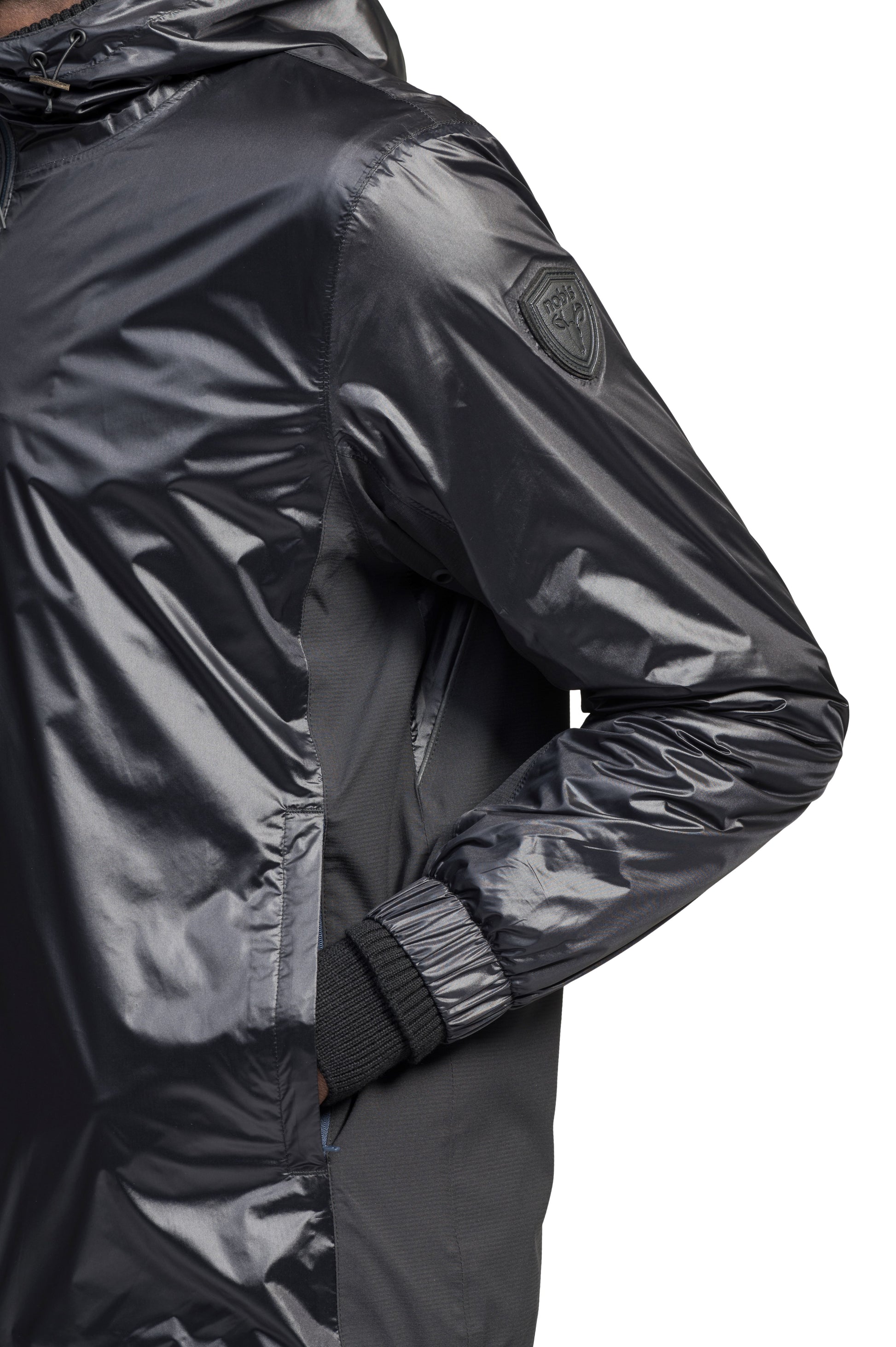 Stratus Men's Tailored Packable Rain Jacket in hip length, premium cire technical nylon taffeta and stretch ripstop fabrication, highly breathable mesh lining, hidden packable pocket, non-removable hood with adjustable draw cord, reflective piping along front and back, underarm grommets for extra breathability, back yoke with mesh ventilation, two waist zipper pockets, two interior zipper pockets, elastic cuffs with adjustable snap button, and adjustable interior draw cord at waist hem, in Black