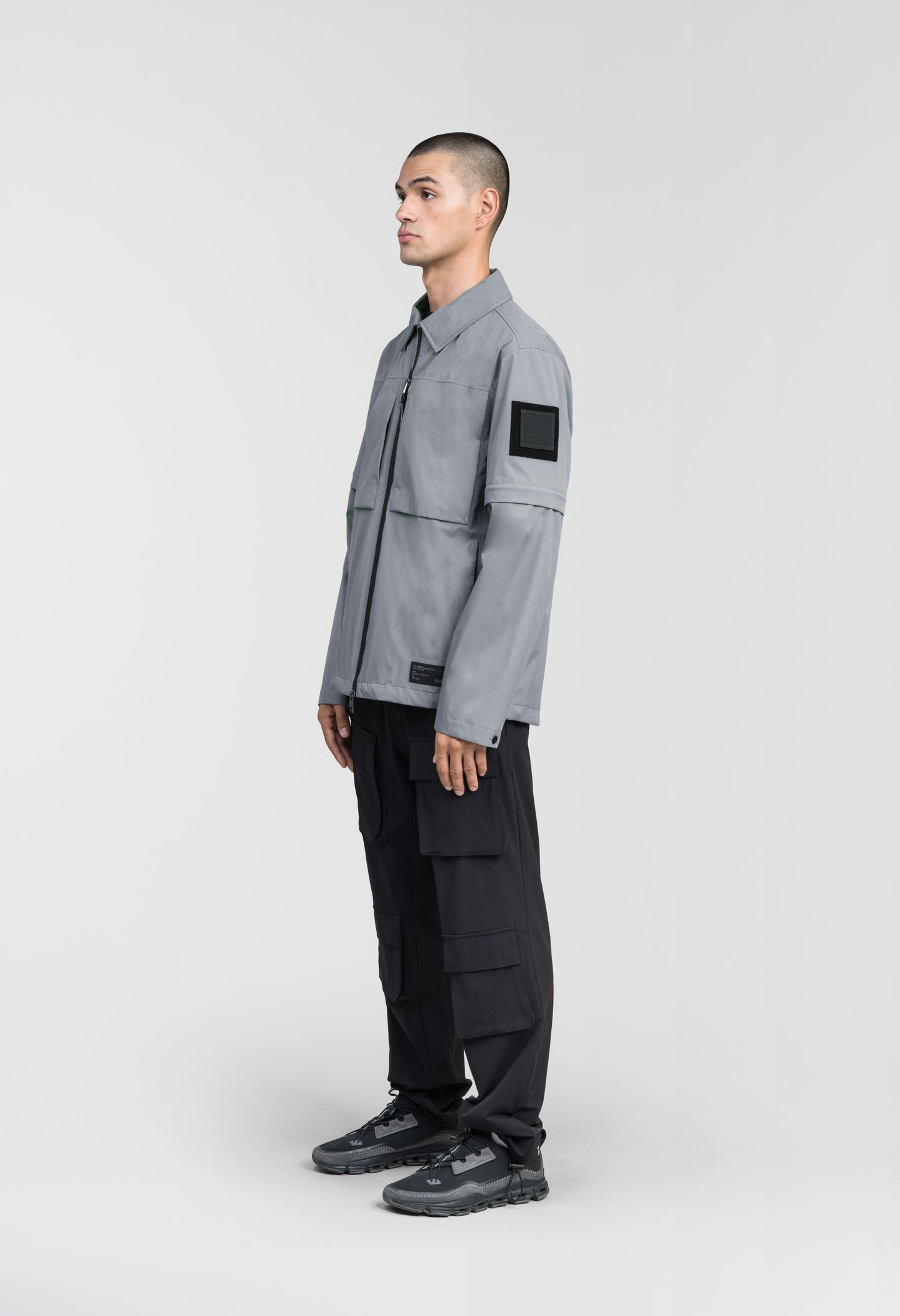 Thurlow Men's Performance Zip Off Sleeve Rain Shirt in hip length, convertible collar, patch chest zipper pockets, hidden in-seam pockets, zip off sleeves, centre front two-way zipper closure, in Concrete