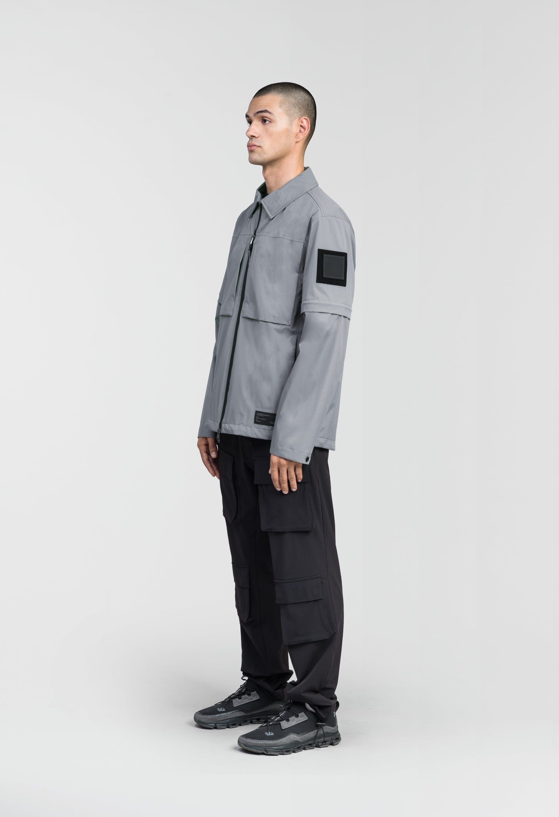 Thurlow Men's Performance Zip Off Sleeve Rain Shirt in hip length, convertible collar, patch chest zipper pockets, hidden in-seam pockets, zip off sleeves, centre front two-way zipper closure, in Concrete