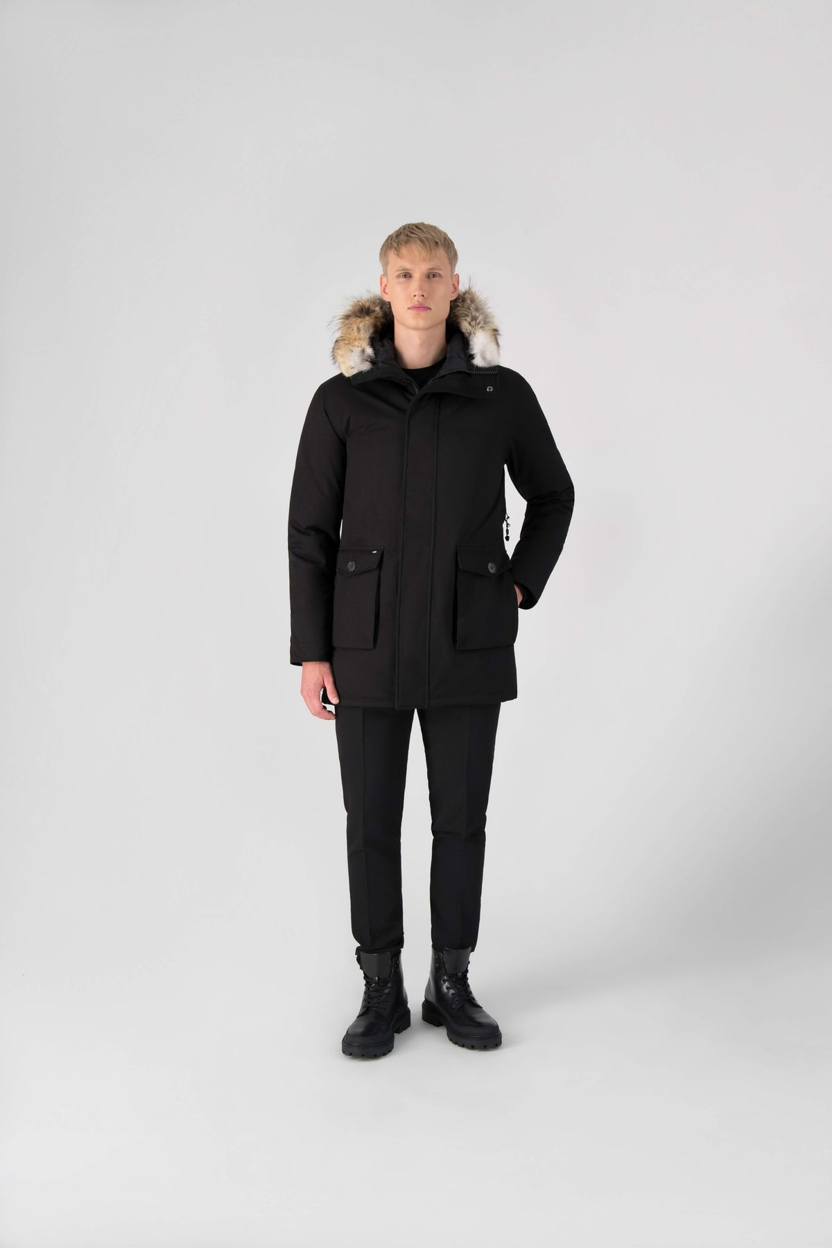Men's slim fitting waist length parka with removable fur trim on the hood and two waist patch pockets in Black