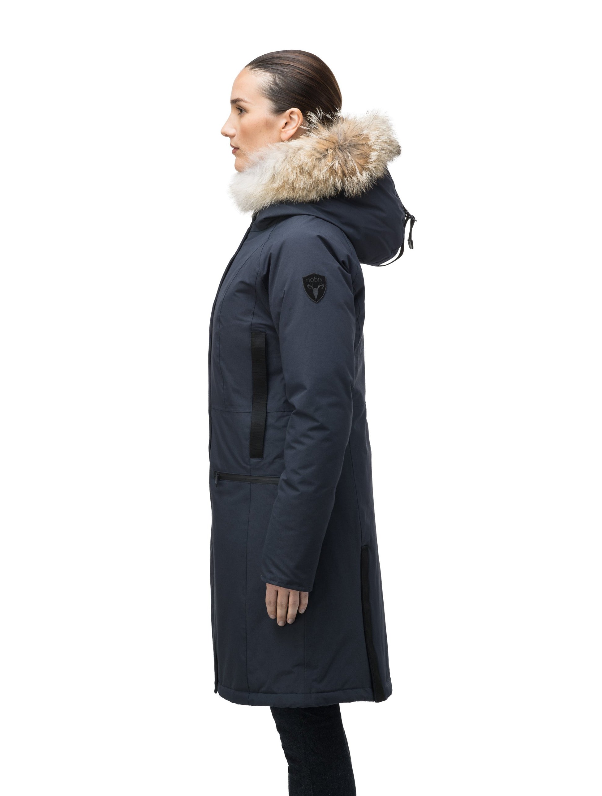 Knee length women's down filled parka with contrast ribbon accents and removable fur trim on the hood in Navy