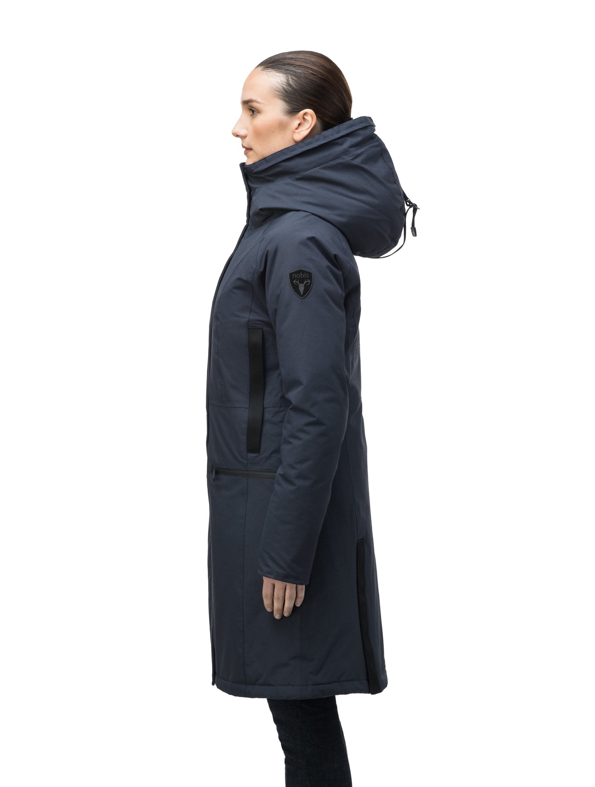 Knee length women's down filled parka with contrast ribbon accents and removable fur trim on the hood in Navy