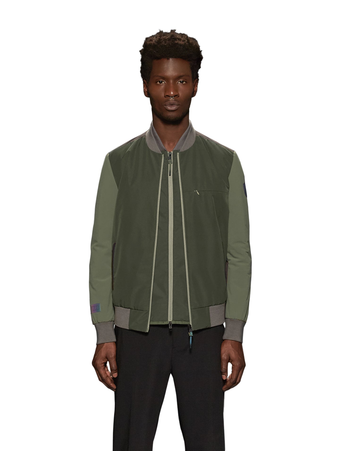 Unisex hip length bomber jacket with a contrast colour back panel, and zipper pockets at waist and an invisible zipper pocket at chest, in Dusty Olive/Licorice