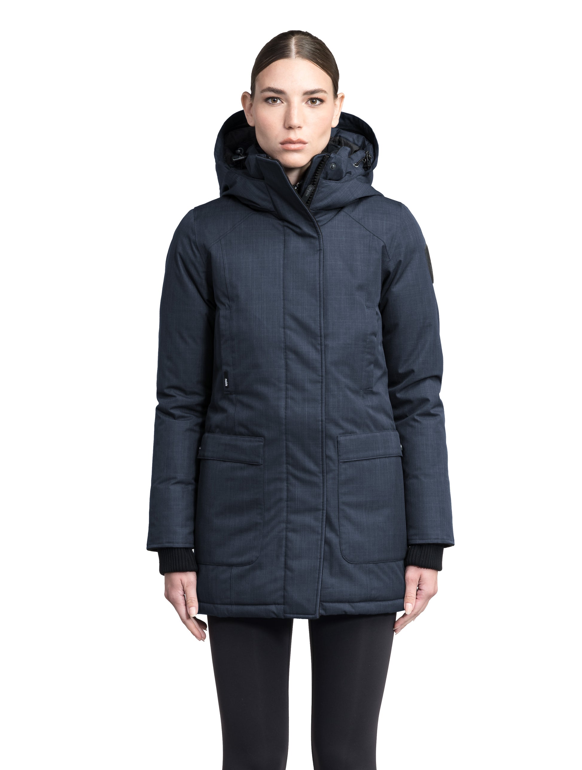 Carla Furless Ladies Parka in thigh length with Canadian Premium White Duck Down insulation, non-removable hood, centre-front zipper with magnetic closure wind flap, and four exterior pockets, in Navy