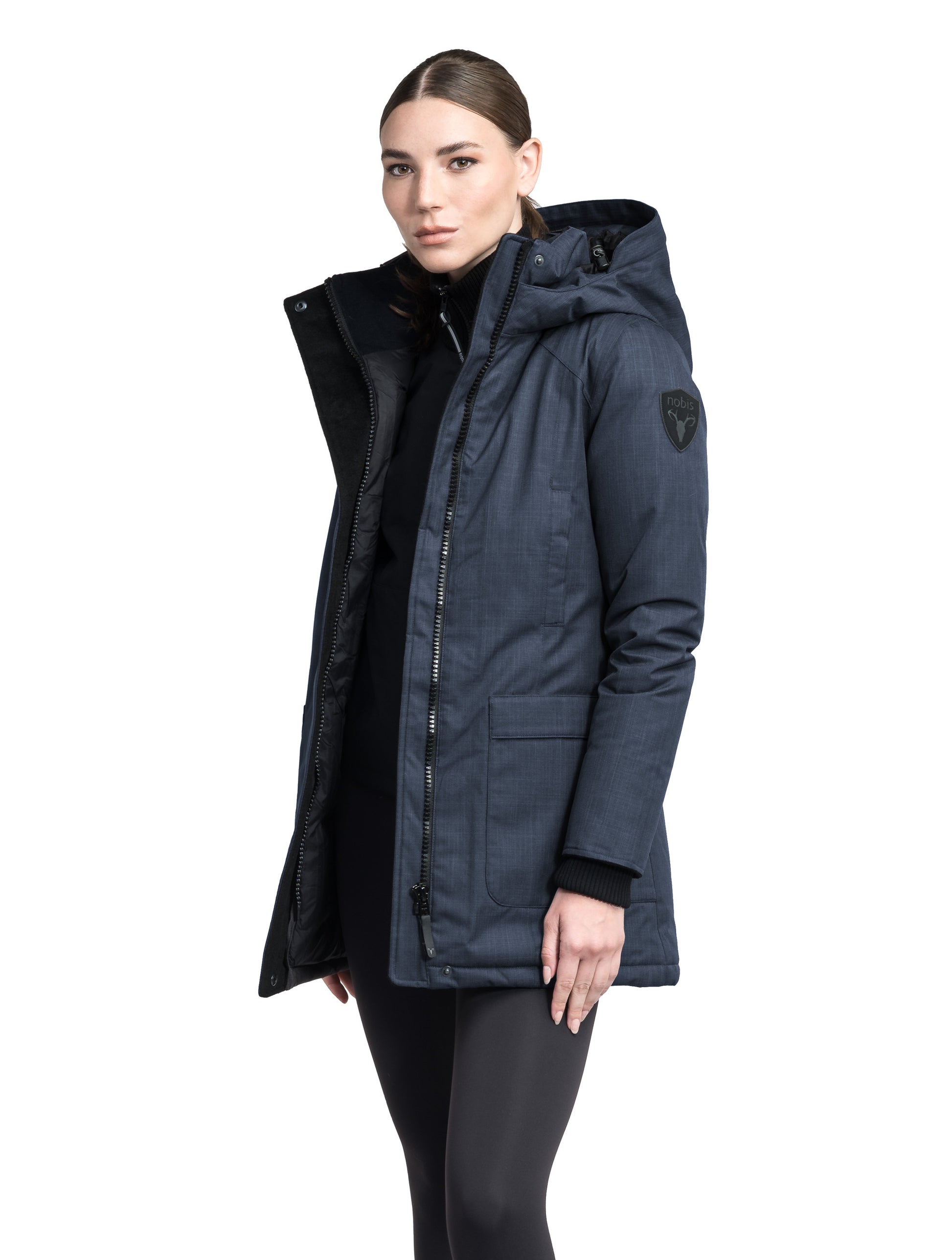 Carla Furless Ladies Parka in thigh length with Canadian Premium White Duck Down insulation, non-removable hood, centre-front zipper with magnetic closure wind flap, and four exterior pockets, in Navy