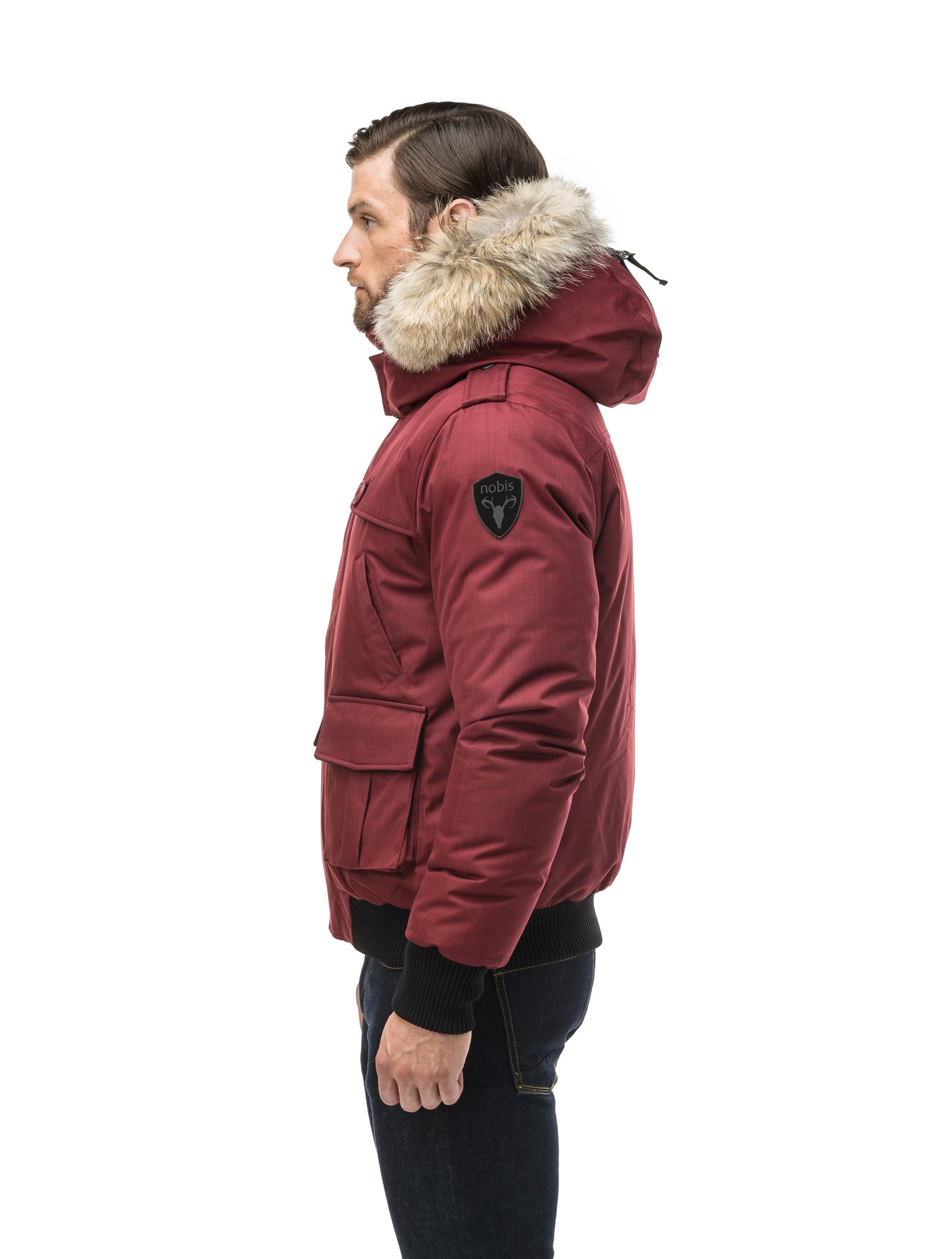 Men's down filled bomber that sits just above the hips with a completely removable hood that's windproof, waterproof, and breathable in CH Cabernet