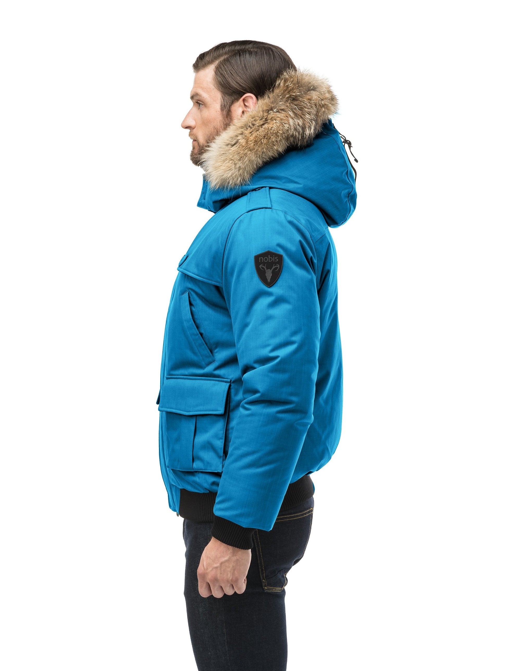 Men's down filled bomber that sits just above the hips with a completely removable hood that's windproof, waterproof, and breathable in Sea Blue