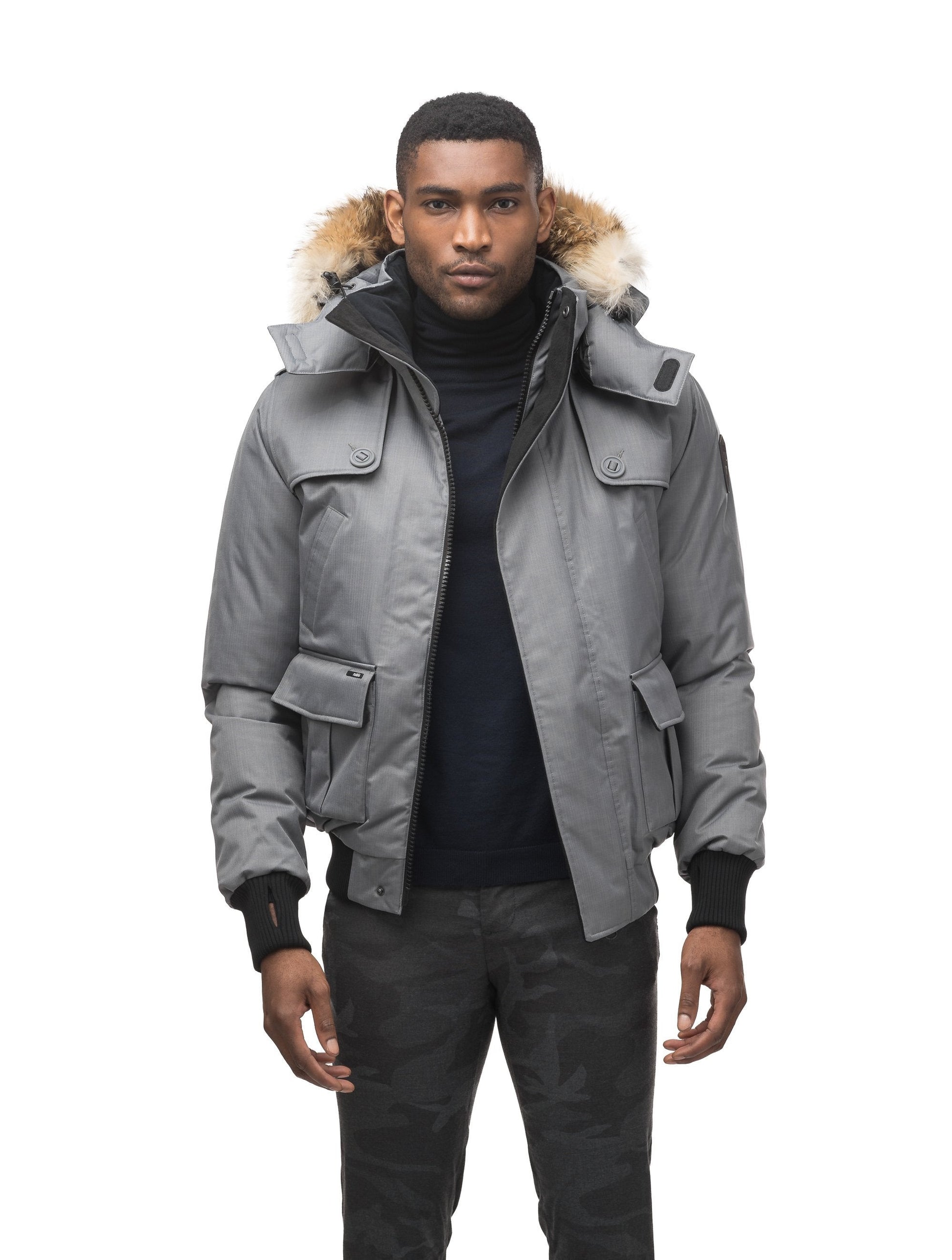 Men's down filled bomber that sits just above the hips with a completely removable hood that's windproof, waterproof, and breathable in CH Concrete