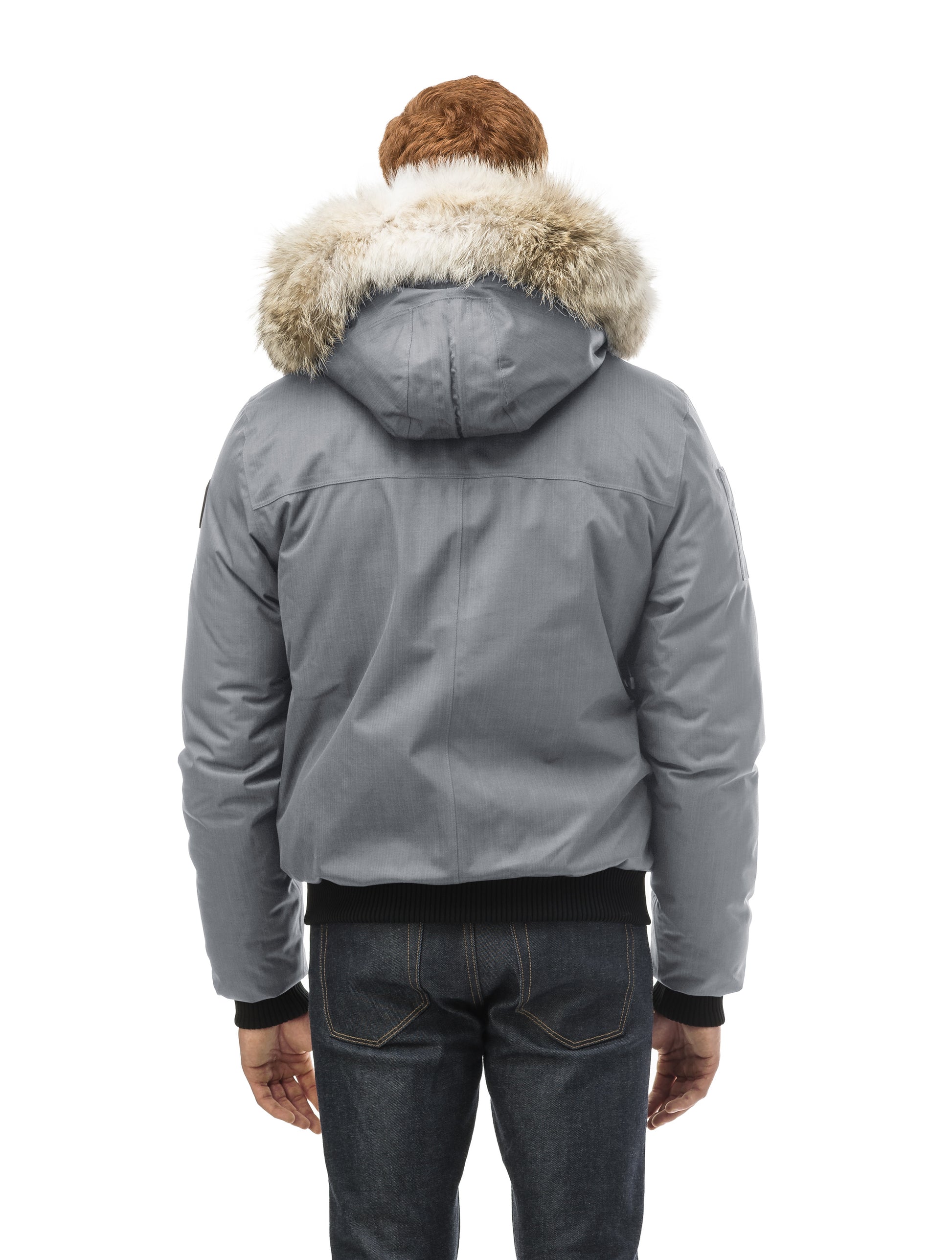 Men's classic down filled bomber jacket with a down filled hood that features a removable coyote fur trim and concealed moldable framing wire in Concrete