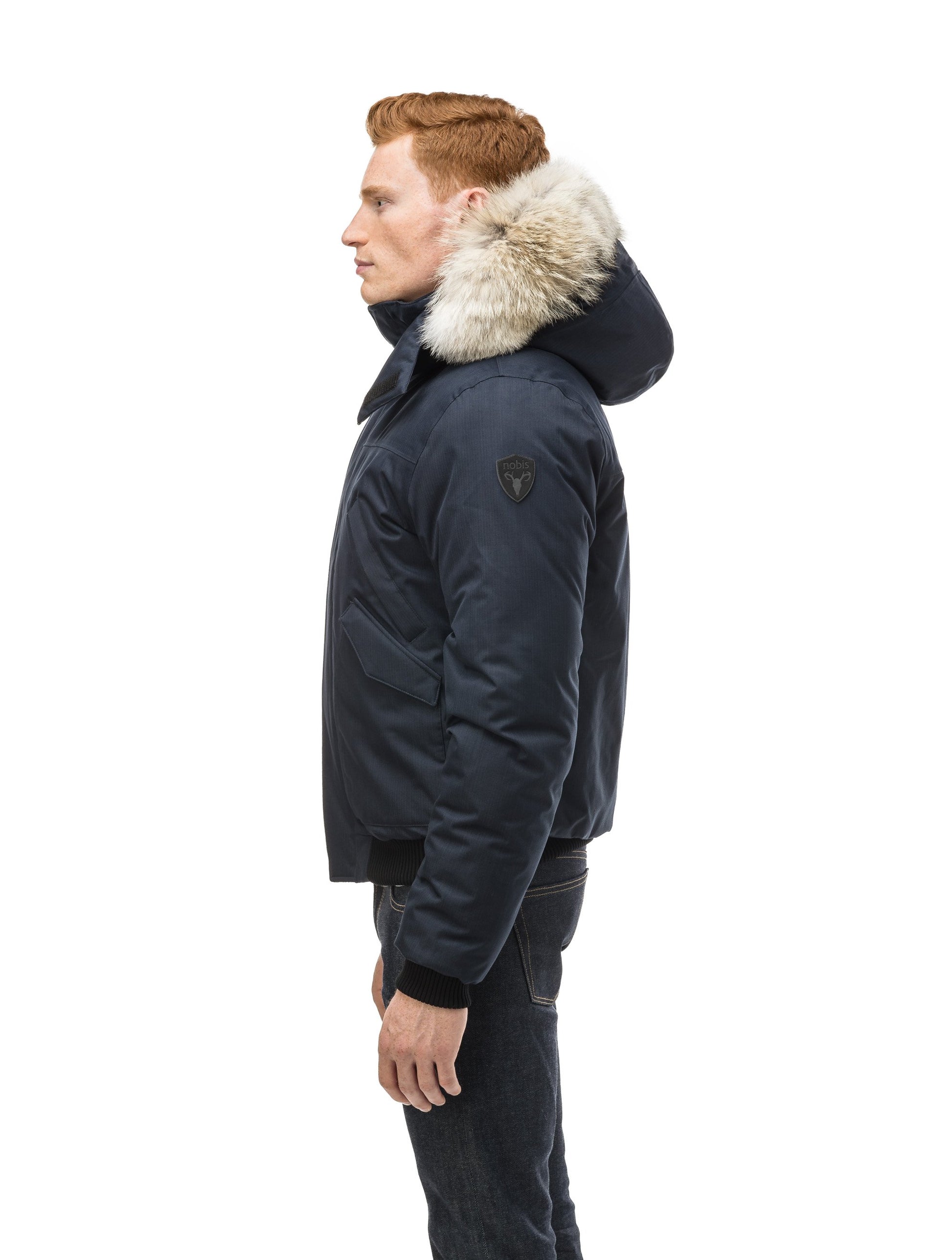 Men's classic down filled bomber jacket with a down filledÃƒâ€šÃ‚Â hood that features a removable coyote fur trim and concealed moldable framing wire in Navy