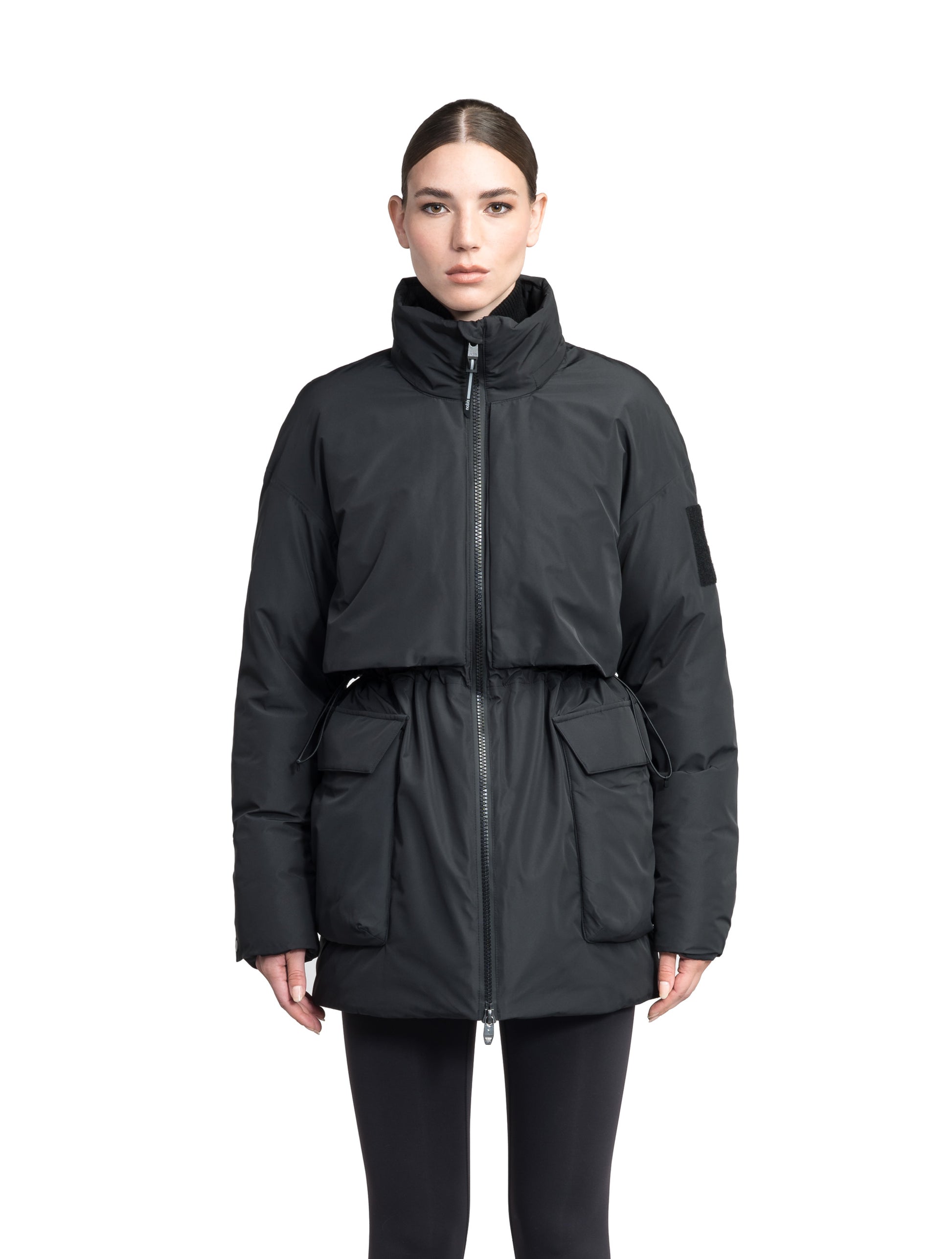 Haelyn Ladies Short Utility Parka in thigh length, 3-Ply Micro Denier fabrication, Premium Canadian White Duck Down insulation, removable down-filled hood, two-way centre front zipper, hidden adjustable cord at waist, adjustable snap cuffs, and four exterior patch pockets at front, in Black