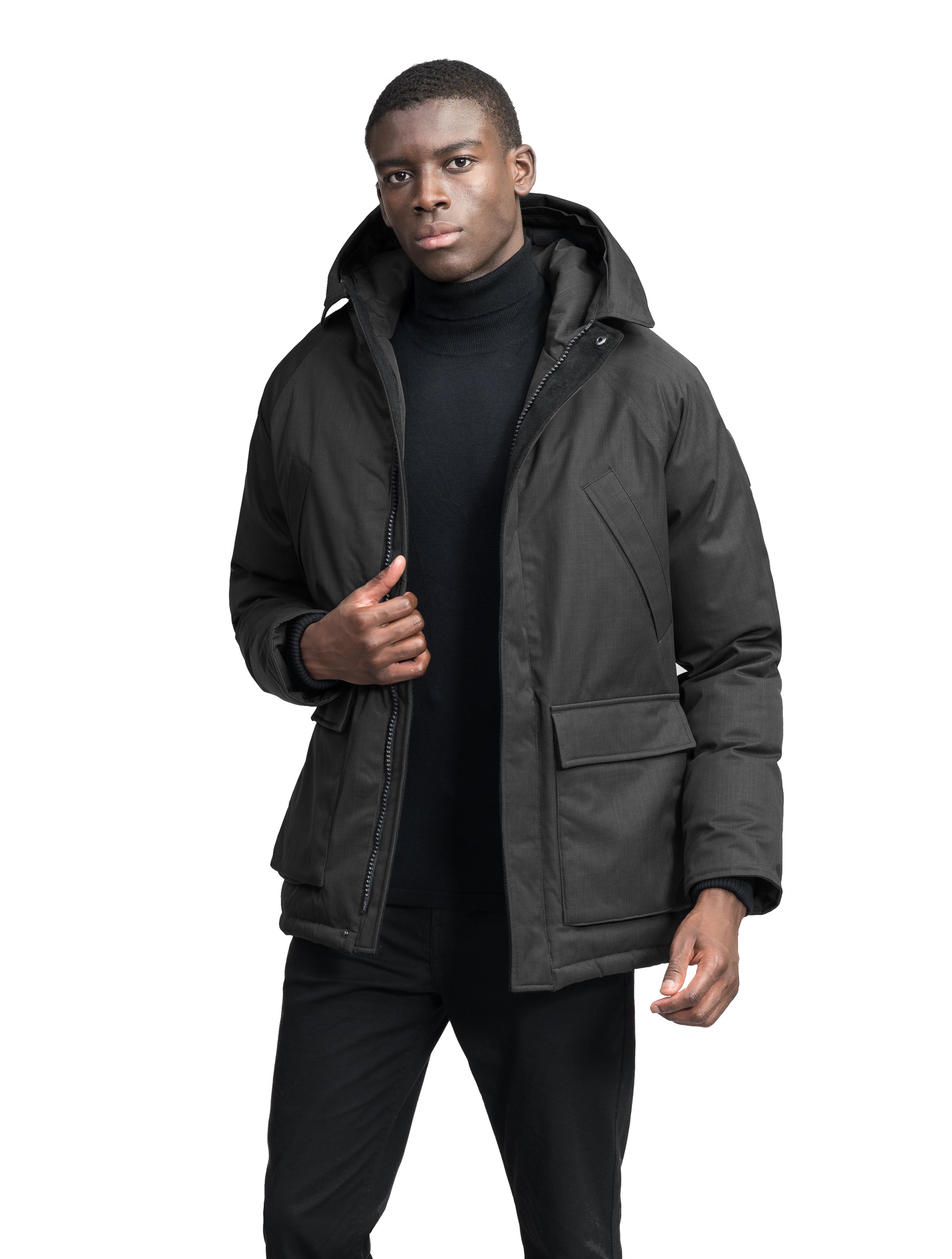 Heritage Furless Men's Parka in hip length, Canadian white duck down insulation, non-removable hood, front zipper with magnetic placket, chest hand warmer pockets, waist flap pockets, and elastic cuffs, in Black