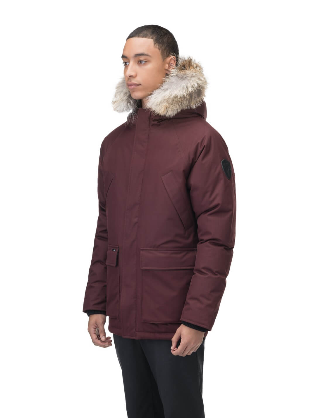 Men's waist length down filled jacket with two front pockets with magnetic closure and a removable fur trim on the hood in Merlot