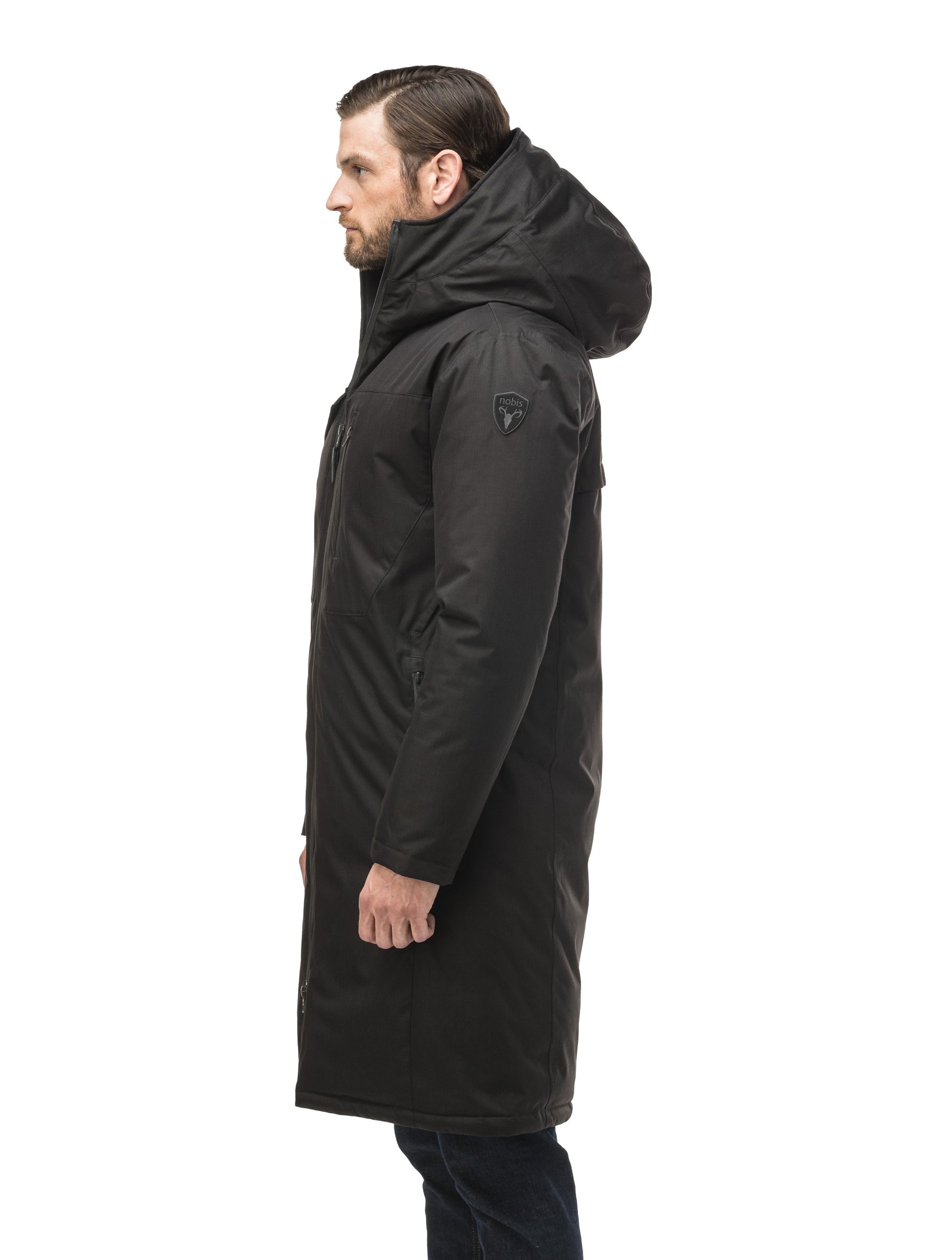 Long men's calf length parka with down fill and exposed zipper that features spacious pockets and zippered vents in Black