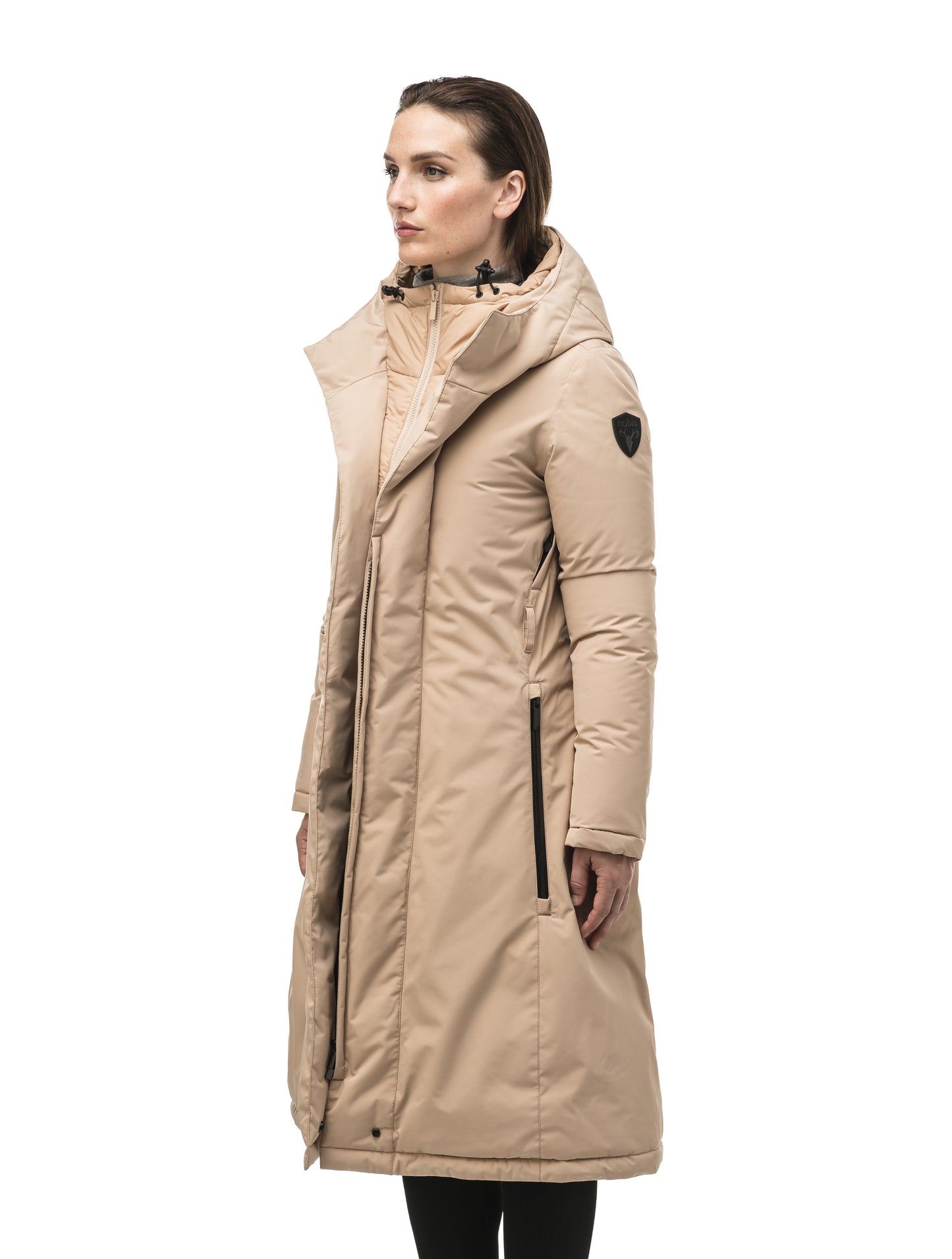 Long calf length hooded women's winter parka with an inner hip length closure, exterior hem length zipper and magentic placket in Fawn