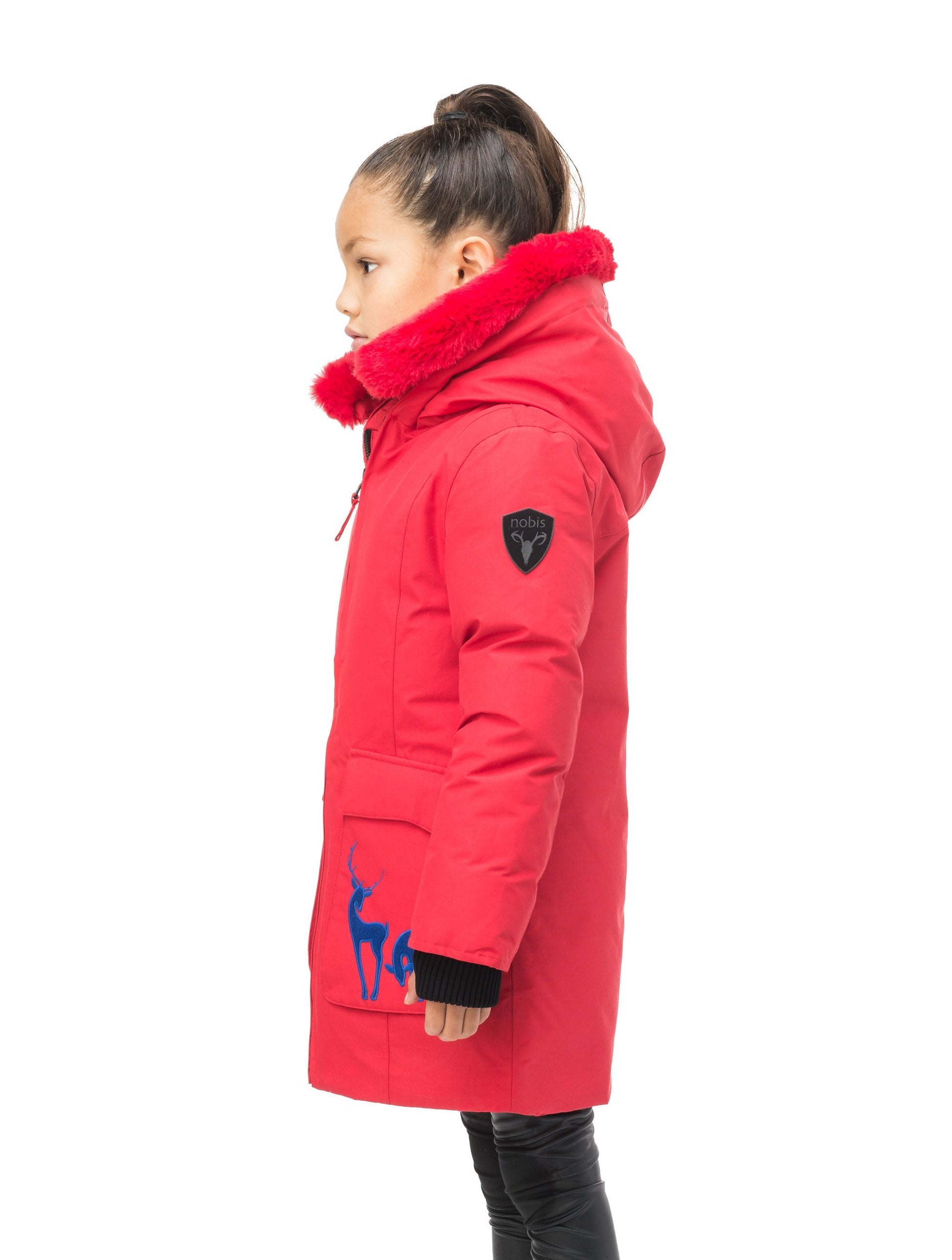 Kid's knee length down filled parka with deer applique detailing on the front patch pockets in Cy Red