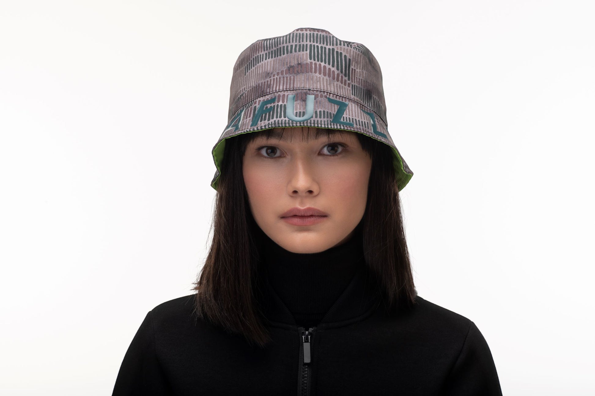 Unisex reversible bucket hat with one side in camouflage and "MAFUZZY" printed on the rim, and the reversed side with the "S" logo printed on the crown in tonal Greenery