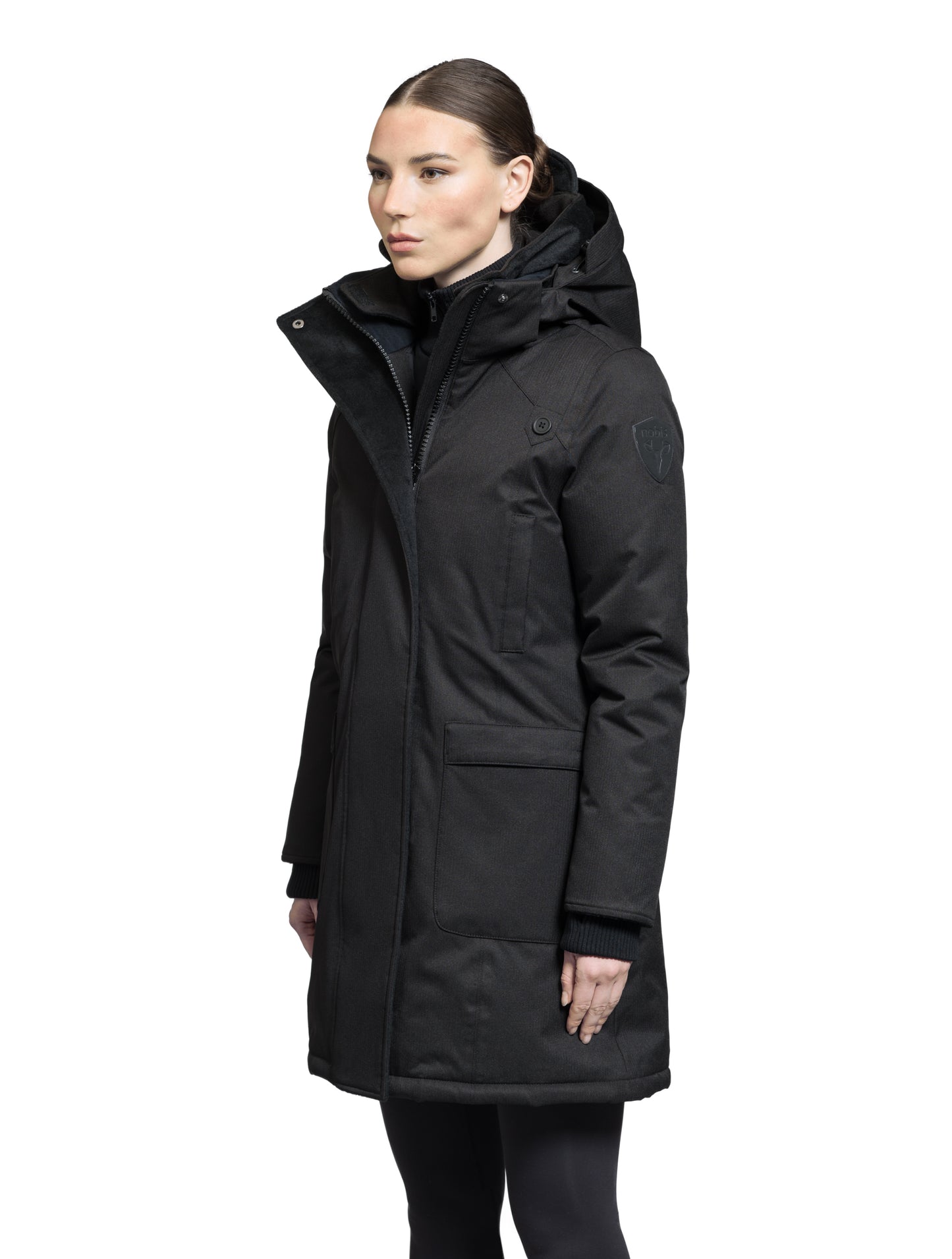 Merideth Furless Ladies Parka in thigh length, Canadian white duck down insulation, removable down-filled hood, centre-front two-way zipper with magnetic wind flap closure, four exterior pockets, and elastic ribbed cuffs, in Black