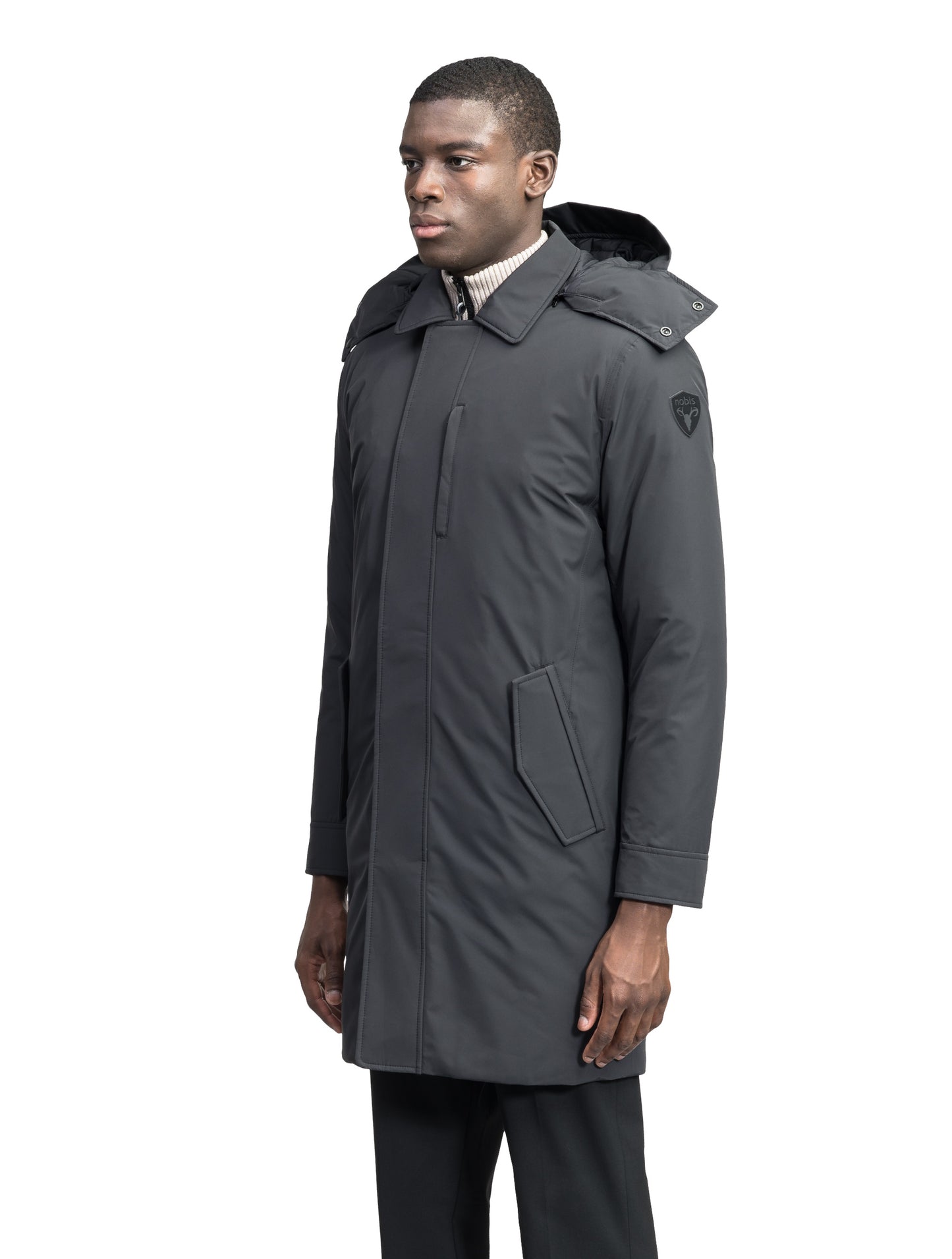 Nord Men's Tailored Trench Coat in knee length, 3-Ply Micro Denier and 4-Way Durable Stretch Weave fabrication, Premium Canadian White Duck Down insulation, removable down-filled hood, exterior zipper pocket at left chest, and adjustable snap button cuffs, in Black