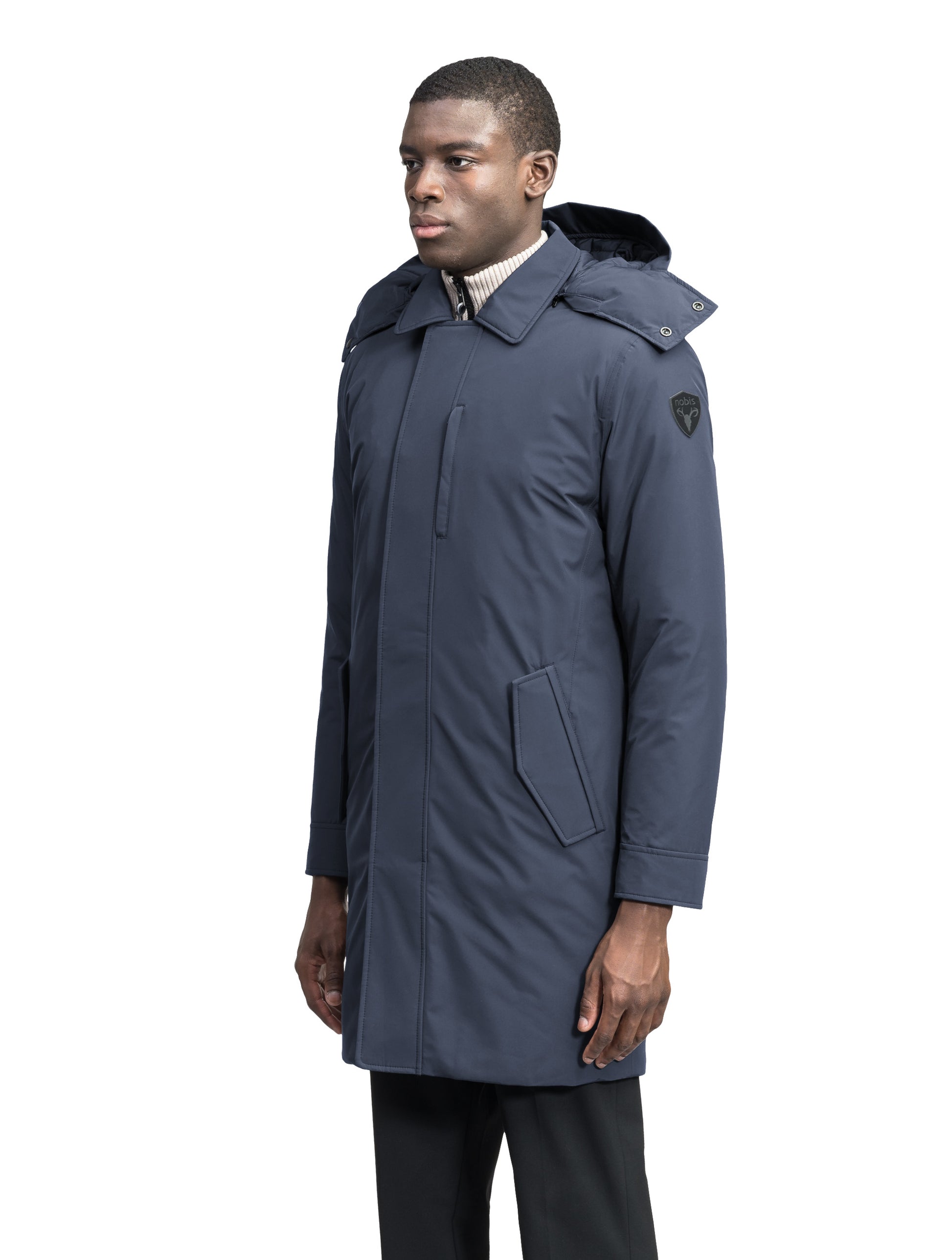 Nord Men's Tailored Trench Coat in knee length, 3-Ply Micro Denier and 4-Way Durable Stretch Weave fabrication, Premium Canadian White Duck Down insulation, removable down-filled hood, exterior zipper pocket at left chest, and adjustable snap button cuffs, in Marine