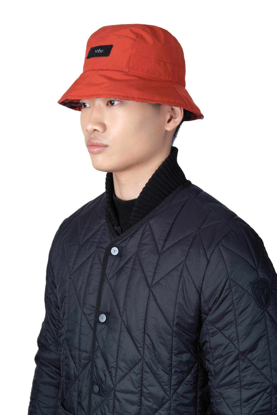 Lunar New Year Reversible Bucket Hat with one side in red tiger print, and the reverse side in tonal red with Nobis label branding on the crown front, in Vermillion