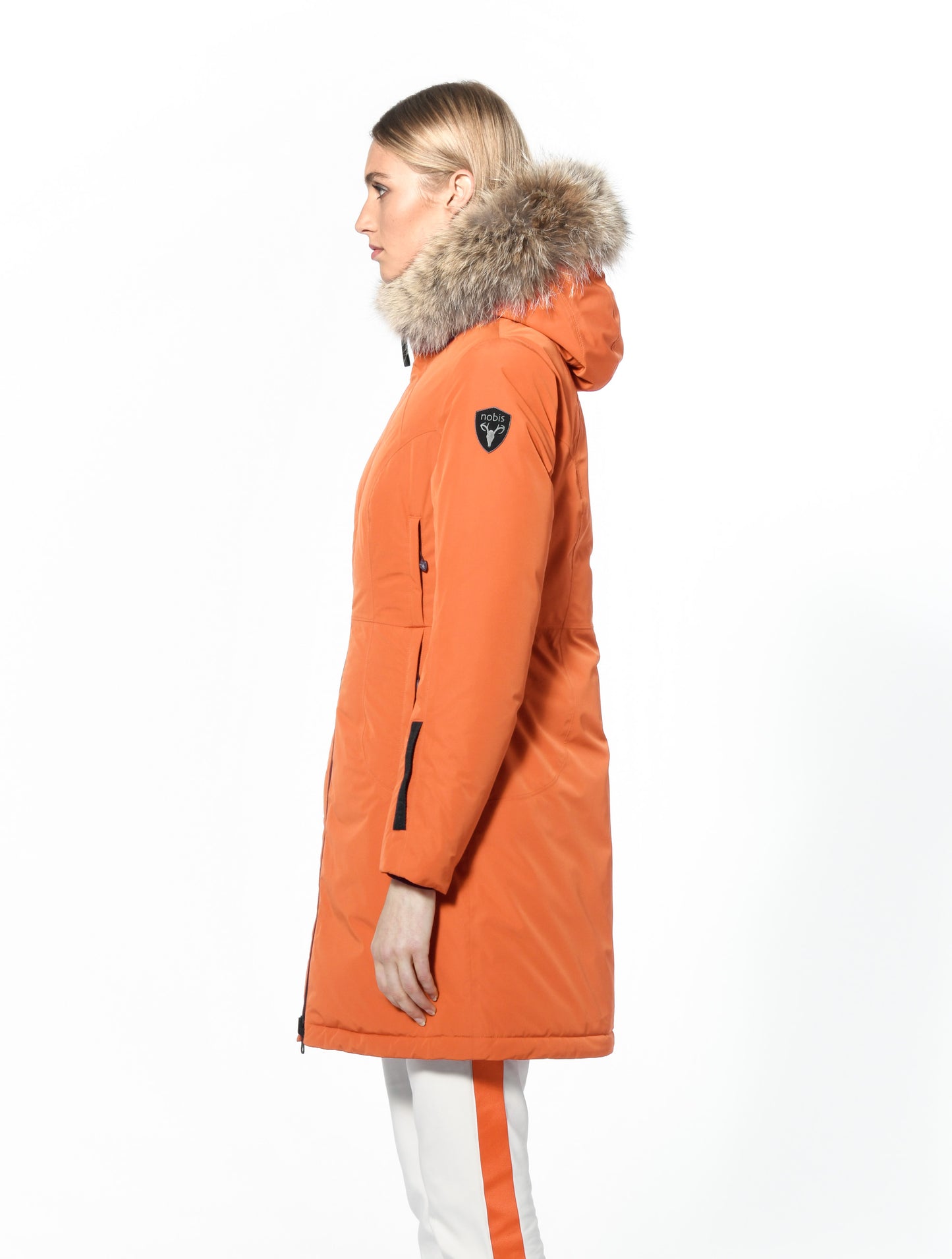 Ladies thigh length down-filled parka with non-removable hood and removable coyote fur trim in Atomic