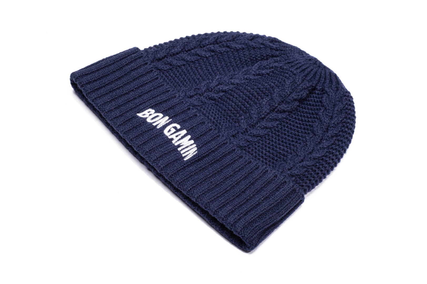 Ciryl Gane x Nobis Cable Knit Beanie with cable stitched body, gathered crown, two by two rib knit cuff, Nobis branded trim wrapped along cuff, flag of France embroidered on the cuff front, and "Bon Gamin" embroidered on the back, in Navy