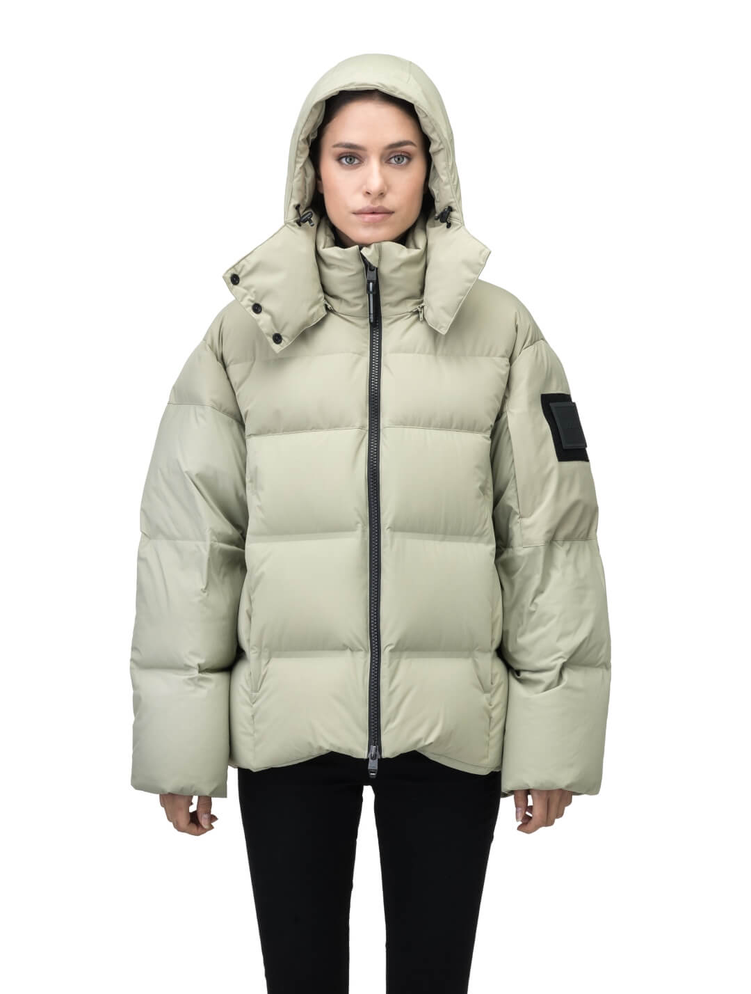 Una Ladies Performance Puffer in hip length, Technical Taffeta and Durable Stretch Ripstop fabrication, Premium Canadian White Duck Down insulation, removable down filled hood, centre front two-way zipper, and side-entry pockets at waist, in Tea