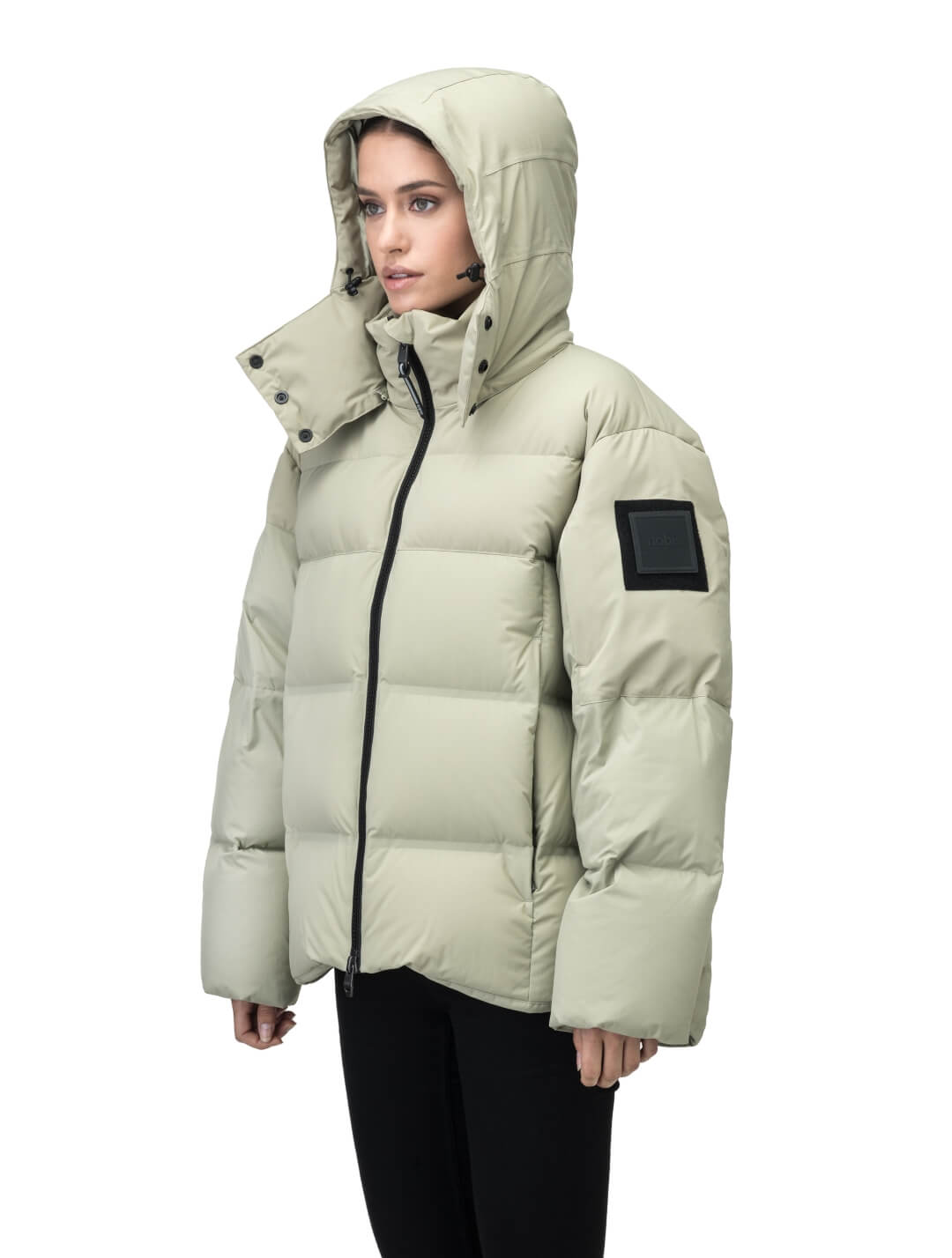 Una Ladies Performance Puffer in hip length, Technical Taffeta and Durable Stretch Ripstop fabrication, Premium Canadian White Duck Down insulation, removable down filled hood, centre front two-way zipper, and side-entry pockets at waist, in Tea