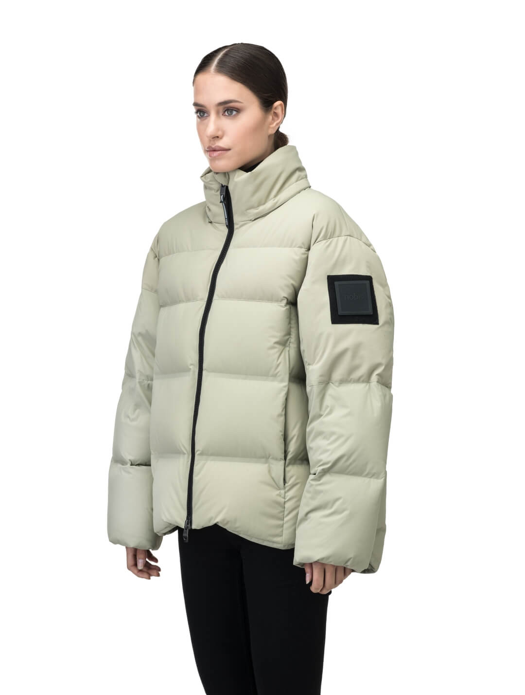 Una Ladies Performance Puffer in hip length, Technical Taffeta and Durable Stretch Ripstop fabrication, Premium Canadian White Duck Down insulation, removable down filled hood, centre front two-way zipper, and side-entry pockets at waist, in Tea