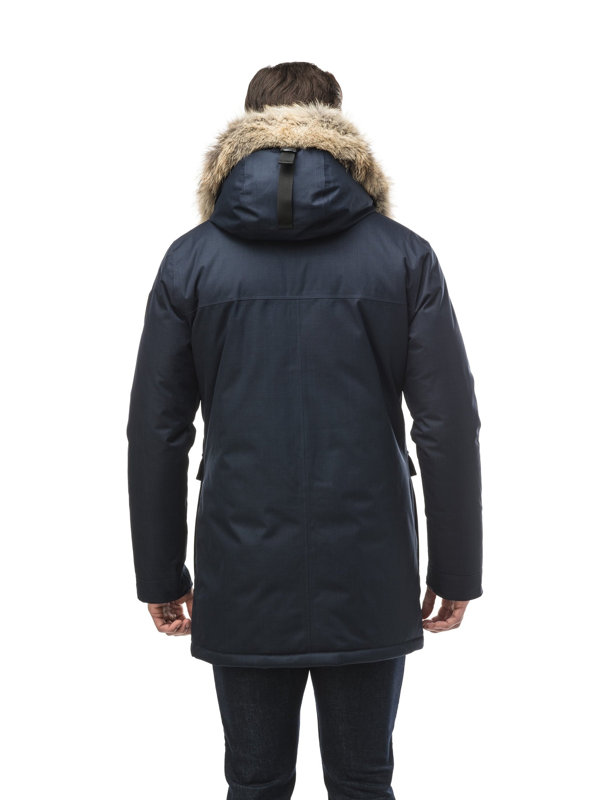 Men's slim fitting waist length parka with removable fur trim on the hood and two waist patch pockets in CH Navy