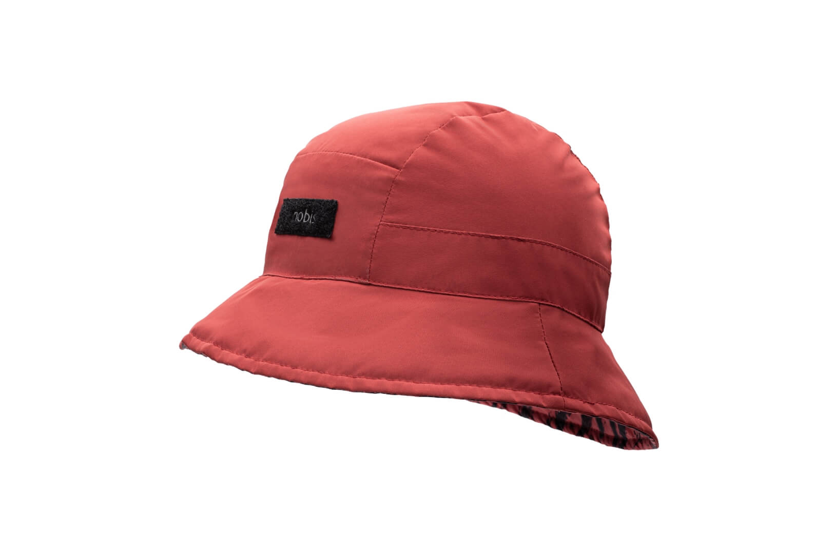 Lunar New Year Reversible Bucket Hat with one side in red tiger print, and the reverse side in tonal red with Nobis label branding on the crown front, in Vermillion